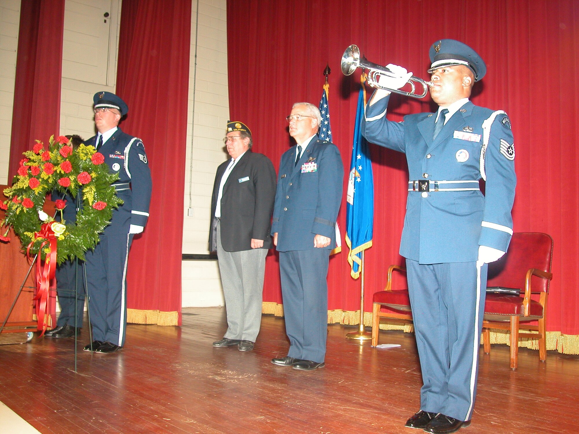 Brig. Gen. James Melin, 452nd Air Mobility Wing commander, and Rees Lloyd, attorney and guest speaker, stand as the honor guard plays taps.  Friends, family members and coworkers from March Field turned out Sept. 21, to participate in the annual MIA/POW ceremony at the cultural center. The guest speaker for the event was Rees Lloyd and among the many distinguished guests in attendance were three former prisoners of war. In addition to traditional ceremonial procedures, the poem In Memories Loving Arms was read by Staff Sgt. Aja Smith. After the ceremony, guests were treated to food and drinks outside on the lawn.  (U.S. Air Force photos by Amy Abbott)