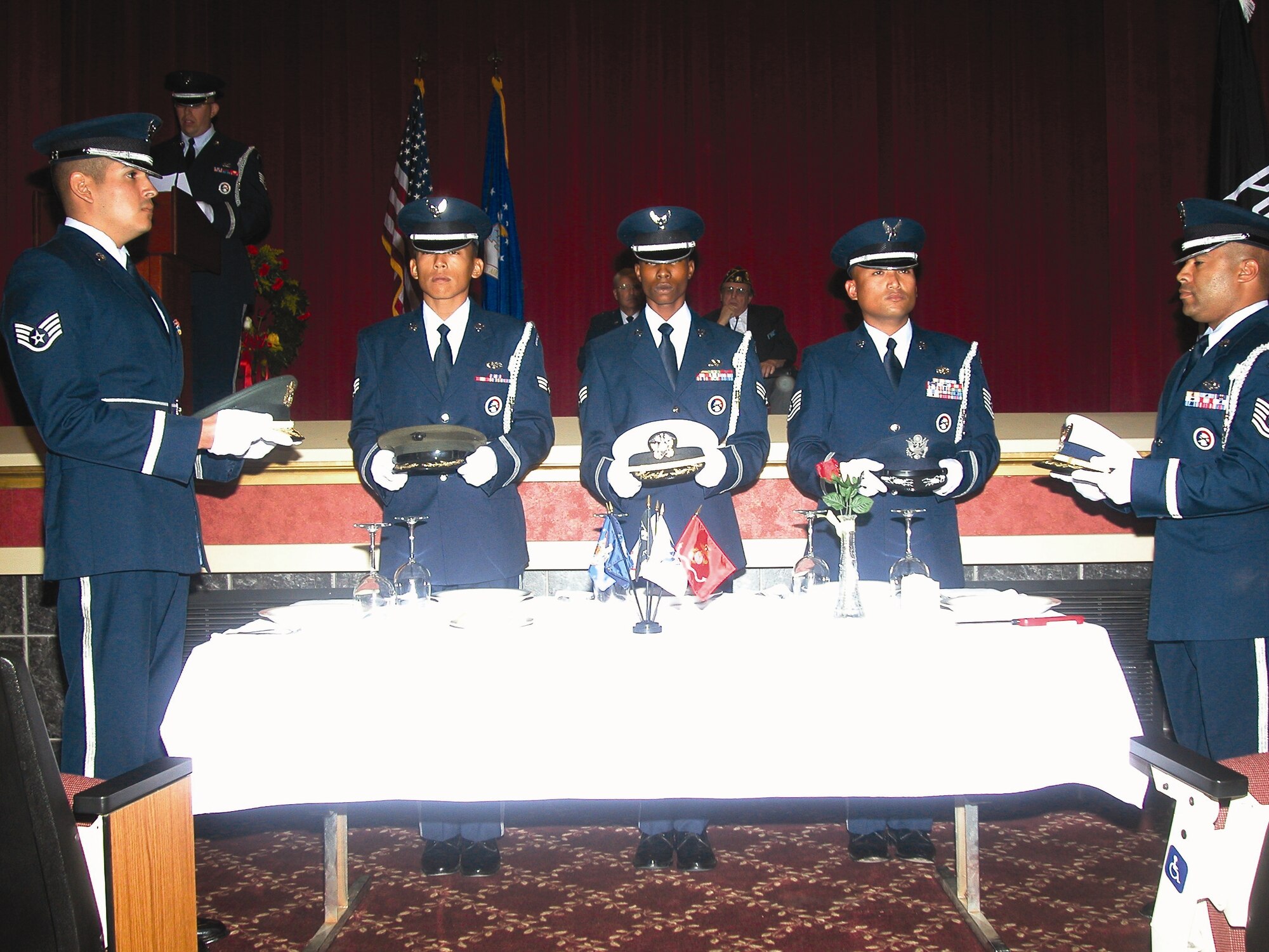 Members of the Blue Eagles Total Force Honor Guard prepared the Missing Man POW/MIA table for the ceremony.  Friends, family members and coworkers from March
Field turned out Sept. 21, to participate in the annual MIA/POW ceremony at the cultural center. The guest speaker for the event was Rees Lloyd and among the many
distinguished guests in attendance were three former prisoners of war. In addition to traditional ceremonial procedures, the poem In Memories Loving Arms was read by Staff Sgt. Aja Smith. After the ceremony, guests were treated to food and drinks outside on the lawn.  (U.S. Air Force photos by Amy Abbott)
