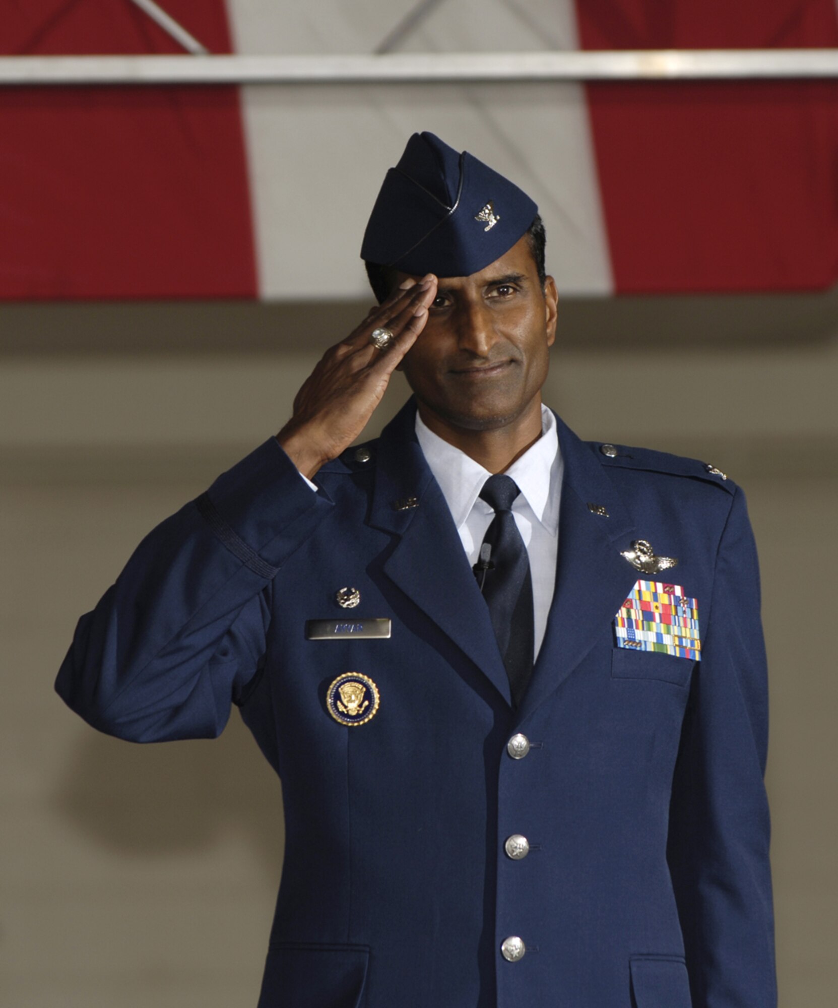 Col. Balan Ayyar renders his first salute as 305th Air Mobility Wing commander to the Airmen of the 305 AMW after assuming command from Brig. Gen. Rick Martin. (U.S. Air Force photo/Kenn Mann)