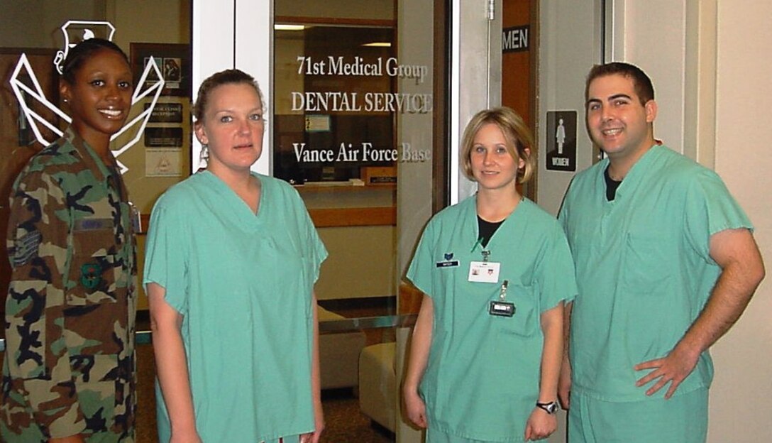 From left to right: Tech Sgt. Shantelle Mingo, non-commissioned officer in charge of dental logistics, Monique Phares, civilian dental assistnat, Staff Sgt. Amy Snyder, periodontal therapist and Capt. Daniel Lipidus, chief of clinical dentistry.