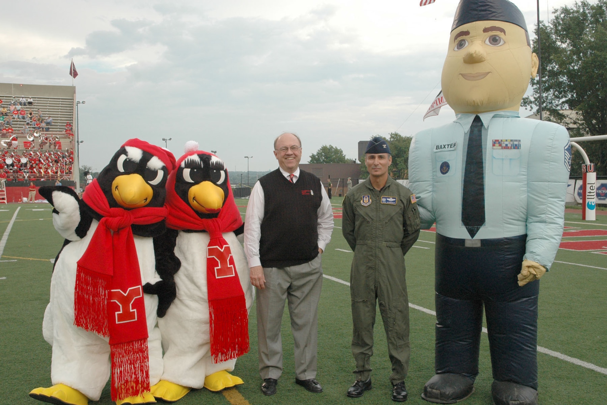 YOUNGSTOWN STATE UNIVERSITY, Ohio — Youngstown State University mascots Pete and Penny Penguin, YSU President Dr. David Sweet, Air Force Reserve 910th Airlift Wing commander Col. Karl McGregor and Air Force Reserve mascot Airman Andy stand on Beede Field at YSU's Stambuagh Stadium just prior to Colonel McGregor presenting his wing commander's coin to Dr. Sweet as part of the celebration of the U.S. Air Force's 60th birthday during the YSU football team's home opener. 370 Airmen, family members and friends from the 910th, based at Youngstown Air Reserve Station, attended a pre-game tailgate lot celebration and the YSU game as part of the USAF's 60th brithday bash. U.S. Air Force photo/ Tech. Sgt. Bob Barko Jr. 