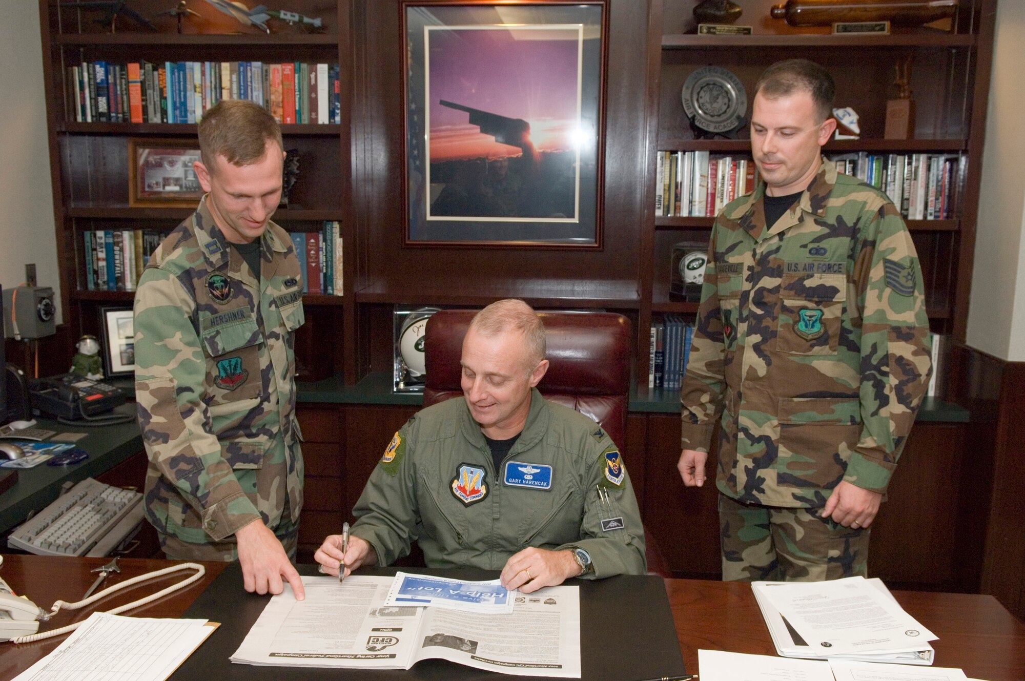 (Center) Col. Garrett Harencak, 509th Bomb Wing commander, signs his contribution for the 2007 Combined Federal Campaign as Capt. Robert Hershner (left), 509th Bomb Wing CFC manager, and Tech. Sgt. Justin Mandeville (right), 509th BW Staff CFC representative, look on. CFC is the world's largest and most successful annual workplace charity campaign, with more than 300 CFC campaigns throughout the country and internationally to help to raise millions of dollars each year. Pledges can be made by military donors during the campaign season, which runs from Oct. 4 - Dec. 15, to support eligible non-profit organizations that provide health and human service benefits throughout the world. (U.S. Air Force photo/A1C Stephen Linch)

