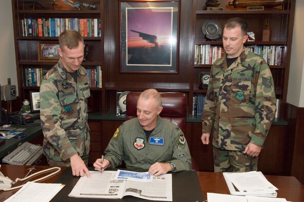 (Center) Col. Garrett Harencak, 509th Bomb Wing commander, signs his contribution for the 2007 Combined Federal Campaign as Capt. Robert Hershner (left), 509th Bomb Wing CFC manager, and Tech. Sgt. Justin Mandeville (right), 509th BW Staff CFC representative, look on. CFC is the world's largest and most successful annual workplace charity campaign, with more than 300 CFC campaigns throughout the country and internationally to help to raise millions of dollars each year. Pledges can be made by military donors during the campaign season, which runs from Oct. 4 - Dec. 15, to support eligible non-profit organizations that provide health and human service benefits throughout the world. (U.S. Air Force photo/A1C Stephen Linch)

