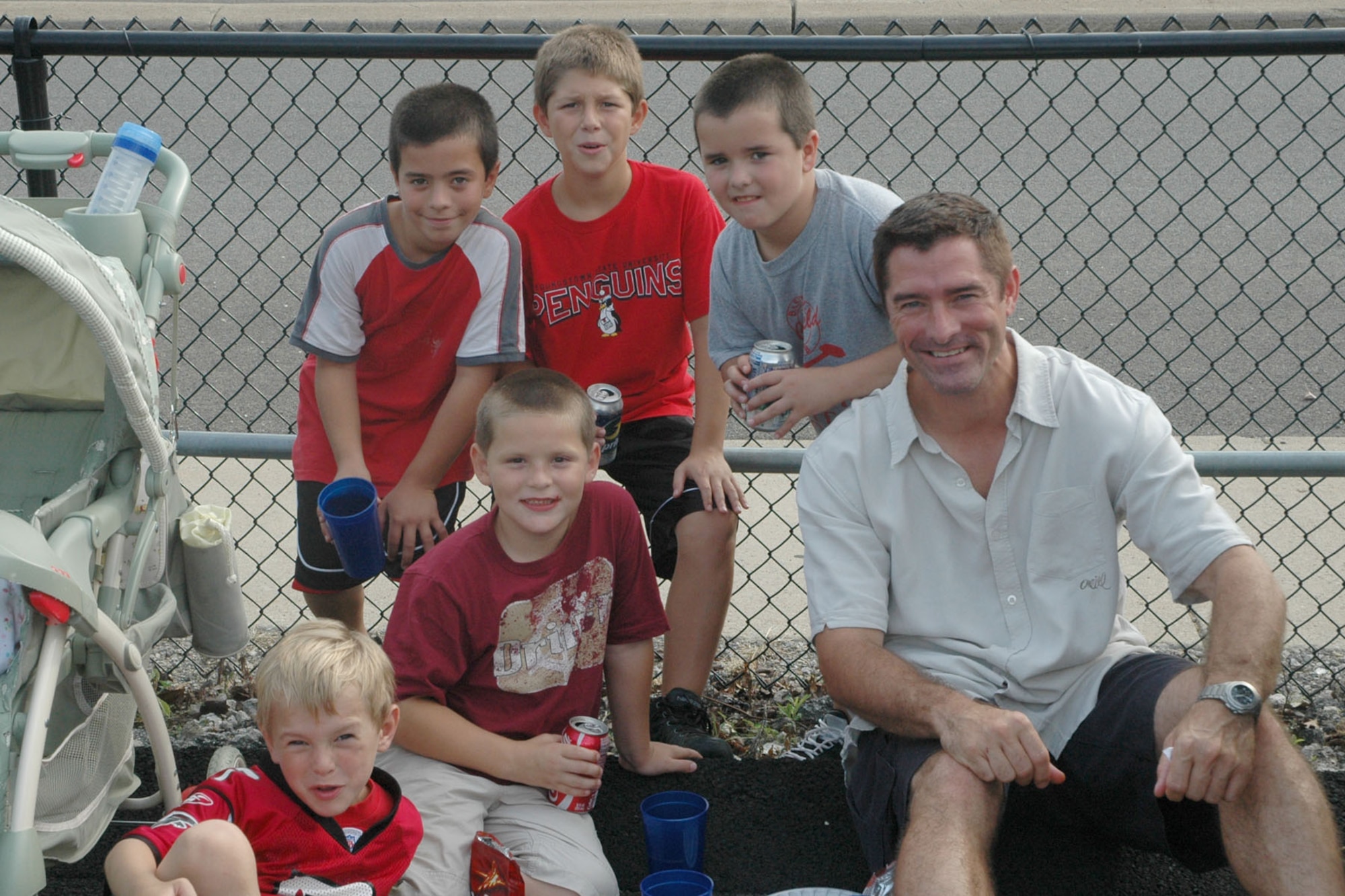 YOUNGSTOWN STATE UNIVERSITY, Ohio — Air Force Reserve Lt. Col. Bill Whittenberger, Operations Officer of the 757th Airlift Squadron  (right), along with a group of young Youngstown State University Penguins football fans, Jacob Whittenberger (front), Richie Hofus, (seated), Luke Whittenberger, Kyle Kovach and Matthew Whittenberger (standing from left), enjoy themselves as 370 Airmen, family members and friends from the 910th, based at Youngstown Air Reserve Station, attended a pre-game tailgate lot celebration and the home opener of YSU's 2007 football season in recognition of the U.S. Air Force's 60th birthday. U.S. Air Force photo/ Tech. Sgt. Bob Barko Jr. 