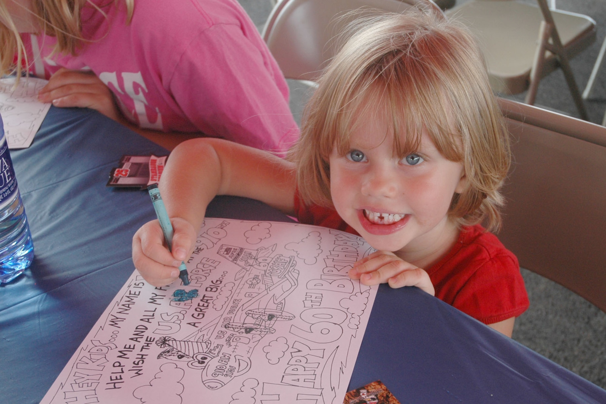 YOUNGSTOWN STATE UNIVERSITY, Ohio — A young guest of the Air Force Reserve 910th Airlift Wing pauses while working on a coloring sheet as 370 Airmen, family members and friends from the 910th, based at Youngstown Air Reserve Station, attended a pre-game tailgate lot celebration and the home opener of Youngstown State University's 2007 football season in recognition of the U.S. Air Force's 60th birthday. U.S. Air Force photo/ Tech. Sgt. Bob Barko Jr. 