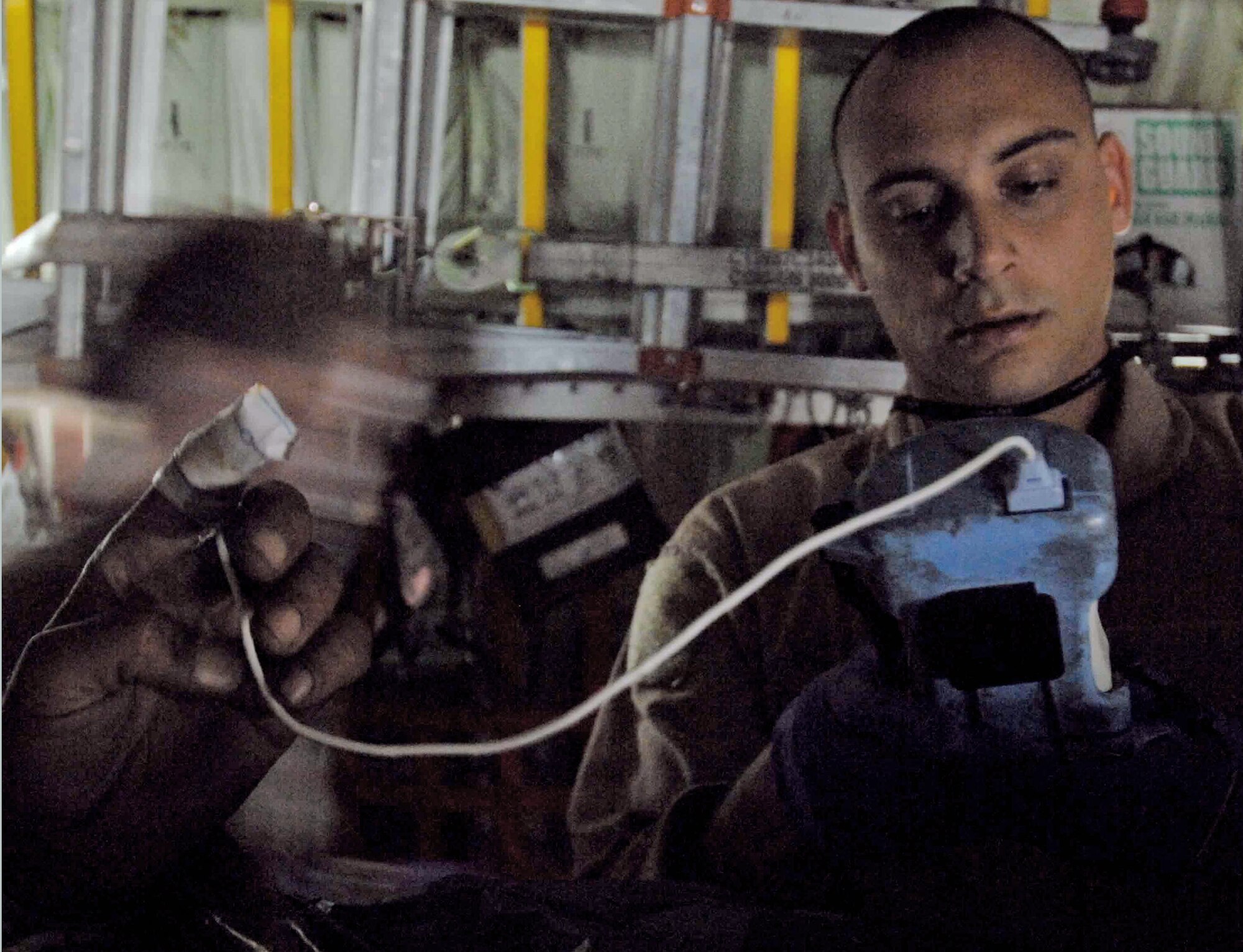 Staff Sgt. Josh Green monitors the oxygen content and heartbeat of an Afghan patient during an Aeromedical evacuation flight out of Afghanistan. The 455th Expeditionary Aeromedical Evacuation Flight team from Bagram Air Base, Afghanistan, utilizes C-130 Hercules aircraft to provide quick aeromedical evacuation response to injured coalition forces, as well as Afghan combatants and civilians. Sergeant Green is a medical technician with the 455th EAEF. (Courtesy photo)