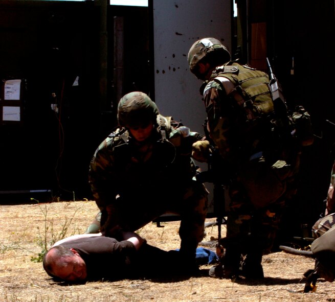 Two 615th Contingency Response Wing Security Forces personnel take down a threatening individual during the Hydra exercise. The 615th CRW will participate in an Operational Readiness Inspection Oct. 10 to 18 Members of the 615th CRW will deploy to Gulfport, Miss., to demonstrate their ability to open up and sustain an operational airbase.(U.S. Air Force photo)