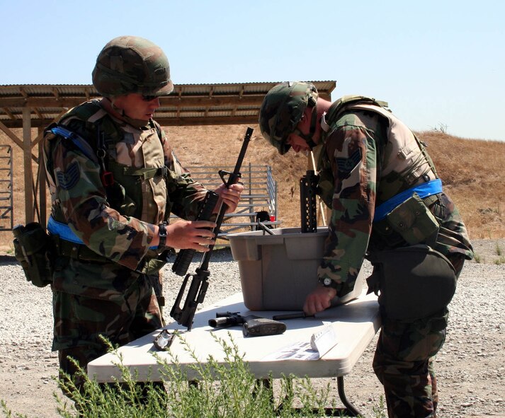 Tech. Sgt. James Sanders, 571st Global Mobility Squadron, and Staff Sgt. Matthew Neely, 571st GMS, assemble an M-16 rifle during the Weapons Soup challenge. Teams were timed on performance and then moved on to the weapons clearing station for a functional check to ensure correct assembly. The 615th Contingency Response Wing will face their first Operational Readiness Inspection Oct. 10 to 18. (U.S Air Force photo)