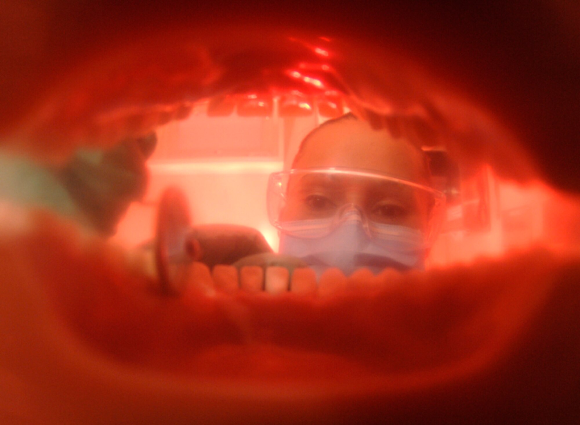 MINOT AIR FORCE BASE, N.D. -- Senior Airman Cynthia Atilano, a dental technician for the 5th Medical Operations Squadron, takes a look inside a set of teeth before scaling calculus (plaque) off them here Oct. 2. Calculus, if not treated, can lead to gum disease. A dental checkup is just one way Airmen can ensure they're in good health. (U.S. Air Force photo by Senior Airman Christopher Boitz)