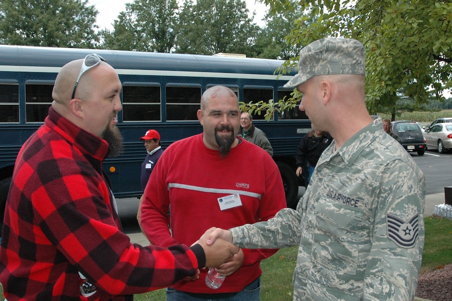 YOUNGSTOWN AIR RESERVE STATION, Ohio — Jason Warren of A.R.E. Accesories, located in Massillon, Ohio, shakes hands with his employee, Tech. Sgt. Kevin McGovern, an Air Force Reservist assigned to the 910th Services Squadron, as Jason McComb, also of A.R.E., looks on. The 910th hosted a group of 38 civilian employers here as part of annual Employer Awareness Day activities. Airmen assigned to the 910th nominated their civilian bosses to attend the event designed to celebrate civilian employers who aid the Air Force mission through support of their employees who are also Air Force Reservists assigned here. U.S. Air Force photo/ Tech. Sgt. Bob Barko Jr.