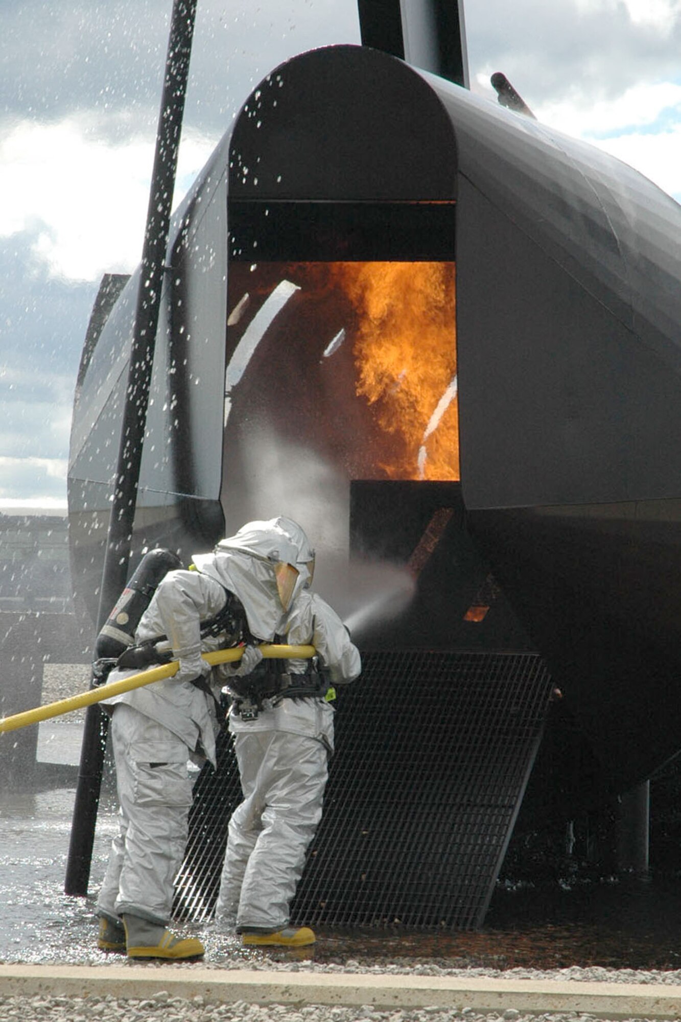 YOUNGSTOWN AIR RESERVE STATION, Ohio — Air Force Reserve firefighters from the 910th Civil engineer Squadron hose down a fire in the aircraft mockup at the "burn pit," an area here used for fire response training, during a demonstration for the annual Eployer Awareness Day. The 910th hosted a group of 38 civilian employers at the base as part of the yearly event. Airmen assigned to the 910th nominated their civilian bosses to attend the event designed to celebrate civilian employers who aid the Air Force mission through support of their employees who are also Air Force Reservists assigned here. U.S. Air Force photo/ Tech. Sgt. Bob Barko Jr.