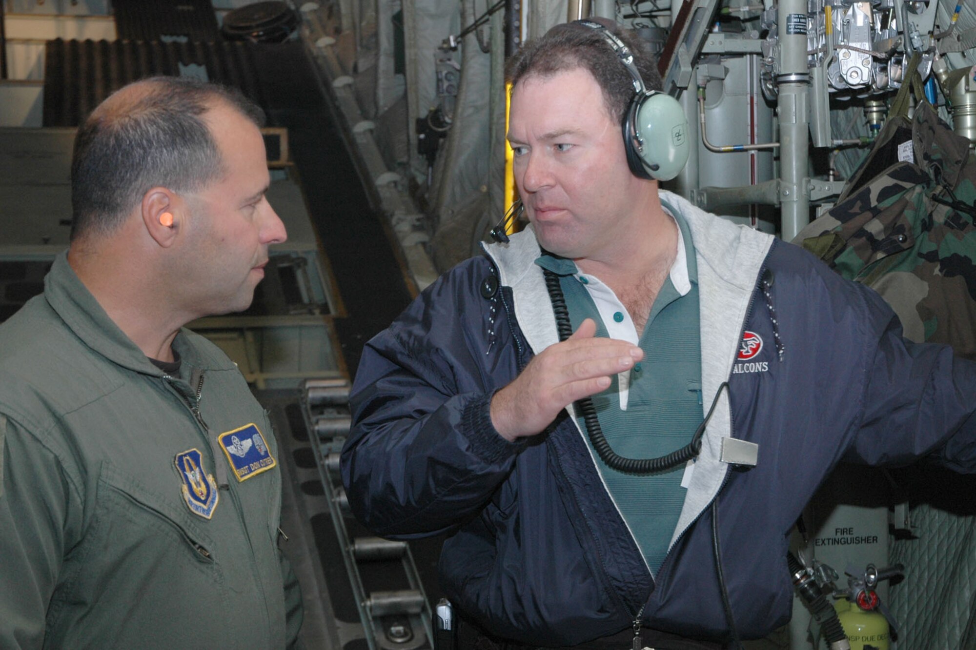 YOUNGSTOWN AIR RESERVE STATION, Ohio — Air Force Reserve Senior Master Sgt. Don Cutrer, a loadmaster assigned to the 757th Airlift Squadron, talks with his employer, Joe Koch of Koch Construction during a C-130 flight to Niagara Falls area as part of Employer Awareness Day activities. The 910th Airlift Wing hosted a group of 38 civilian employers at the base for the annual Employer Awareness Day. Airmen assigned to the 910th nominated their civilian bosses to attend the event designed to celebrate civilian employers who aid the Air Force mission through support of their employees who are also Air Force Reservists assigned here. U.S. Air Force photo/ Tech. Sgt. Bob Barko Jr.