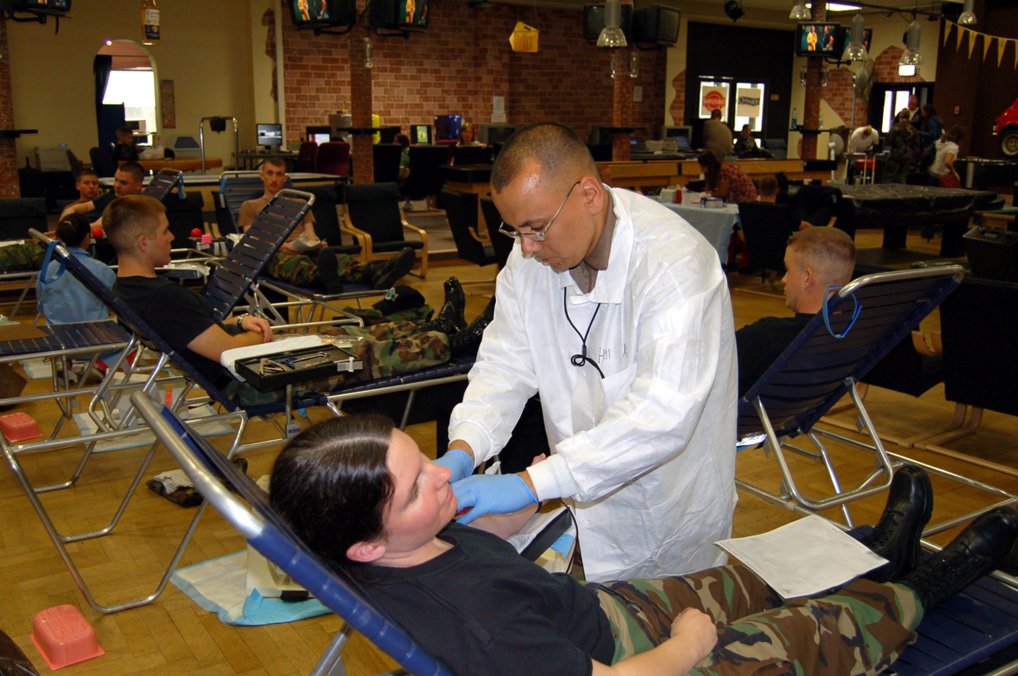 SPANGDAHLEM AIR BASE, Germany – Navy Petty Officer 1st Class Brian King, Landsthul Regional Medical Center, checks on Tech. Sgt. Shara Lewis, 52nd Logistics Readiness Squadron, as she donates blood during a base blood drive Oct. 2. (U.S. Air Force photo/Staff Sgt. Tammie Moore)