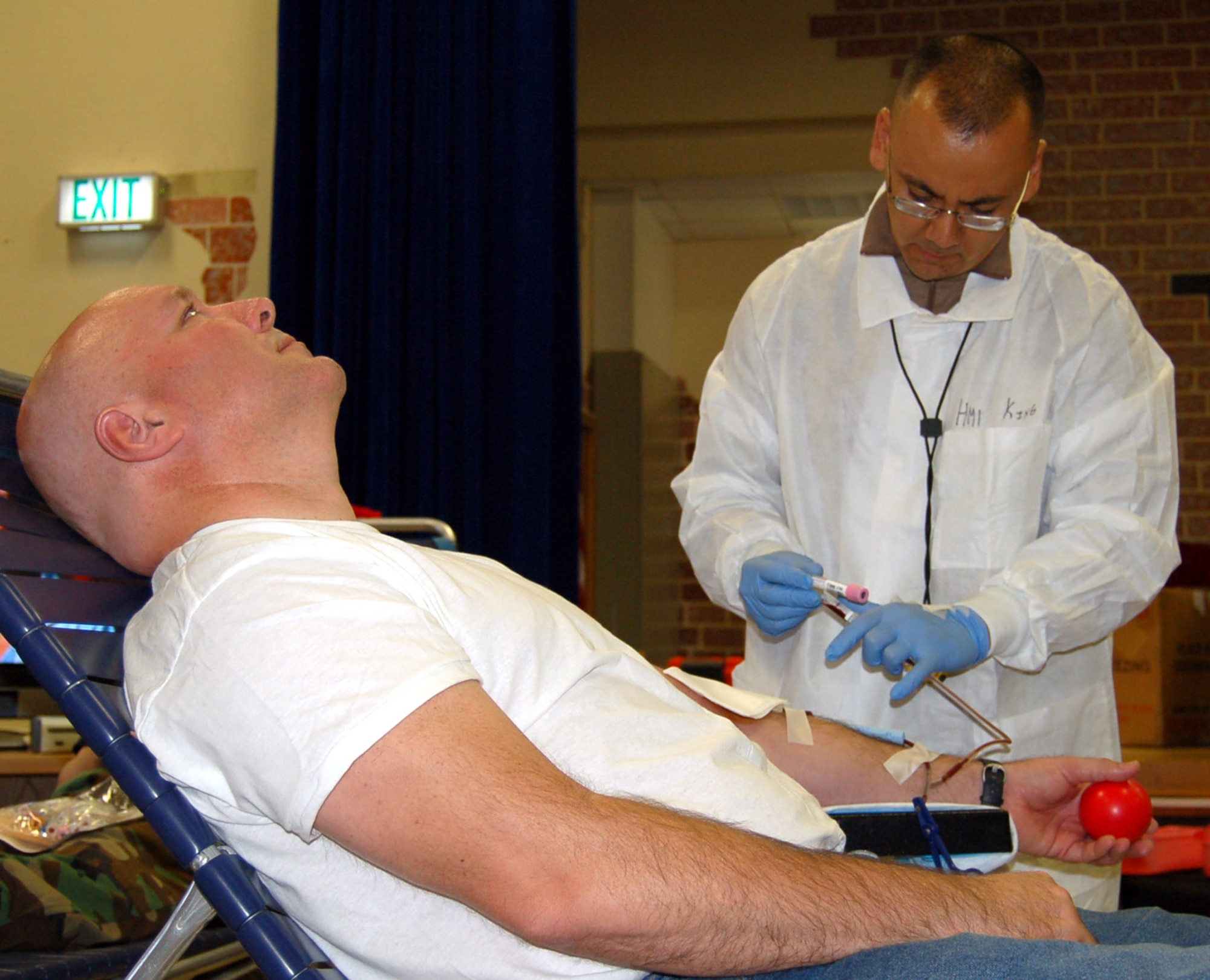 SPANGDAHLEM AIR BASE, Germany – Navy Petty Officer 1st Class Brian King, Landsthul Regional Medical Center, drawls blood from Mike Skillman during a base blood drive Oct. 2. Mr. Skillman is at Spangdahlem Air Base visiting his son, Senior Airman Mitchell Skillman, 52nd Civil Engineer Squadron. (U.S. Air Force photo/Staff Sgt. Tammie Moore)
