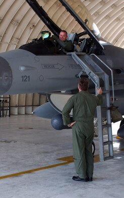 Lt. Col. Shane Riza is greeted by Lt. Col. Thomas Klopotek at Kunsan Air Base, South Korea, Oct. 2 after flying a new Block 40 F-16 Fighting Falcon to Kunsan from Eielson Air Force Base, Alaska.  The upgraded fighter was the first of several F-16s the 8th Fighter Wing was receiving as part of the Common Configuration Implementation Program.  Colonel Klopotek is the 80th Fighter Squadron commander.  Colonel Riza is the 80th FS director of operations.  (U.S. Air Force photo/Senior Airman Steven R. Doty)