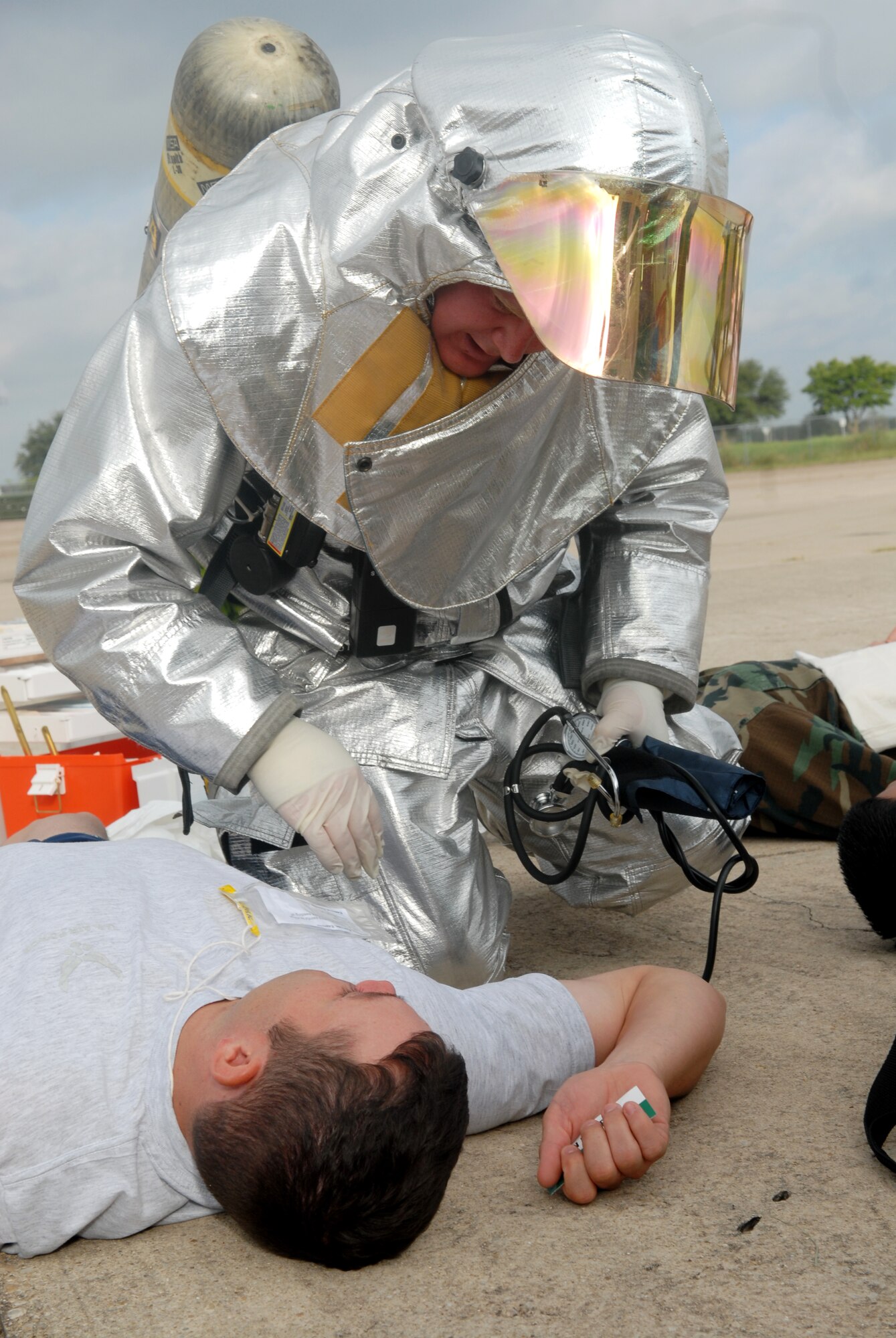 Firefighters from San Angelo Regional Airport /Mathis Field examine a student from Goodfellow portraying a disaster victim at the MARE Sept. 20. (U.S. Air Force photo by Airman 1st Class Kamaile Chan)