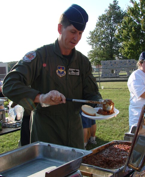 71st Flying Training Wing Commander Col. Richard Klumpp Jr. serves up barbecue sandwiches to hungry patrons at Fall Fest 2007.  More than 800 people attended the annual event Oct. 4 at the Vance Youth Center. (U.S. Air Force photo by Tech. Sgt. Mary Davis)