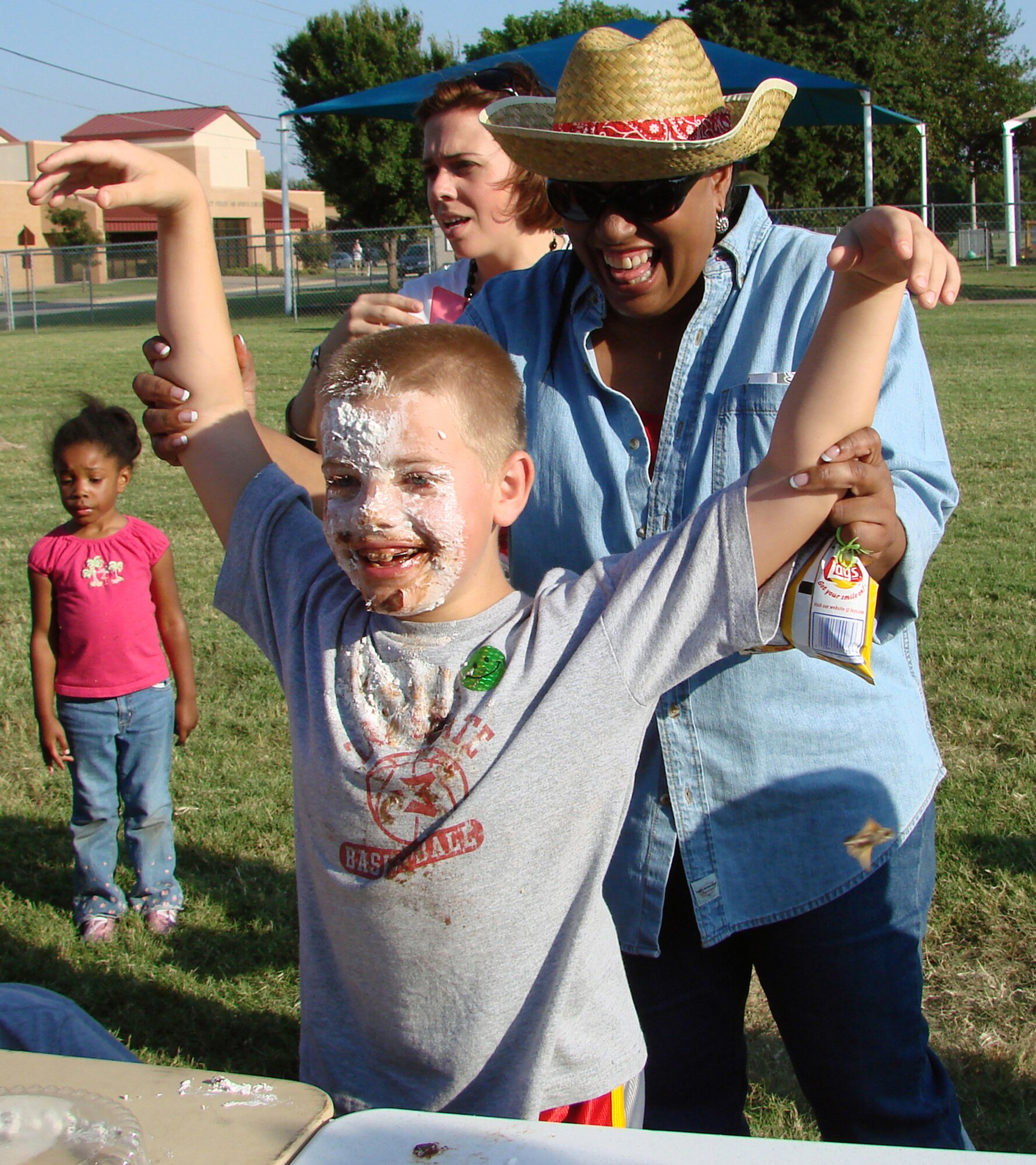 Daniel Stewart, 8, is named the winner of a pie-eating contest by Diane McCurdy, Services flight chief, during Fall Fest 2007. Daniel is the son of Laura and Lt. Col. David Stewart, 71st Communications Squadron commander. (U.S. Air Force photo by Tech. Sgt. Mary Davis)  