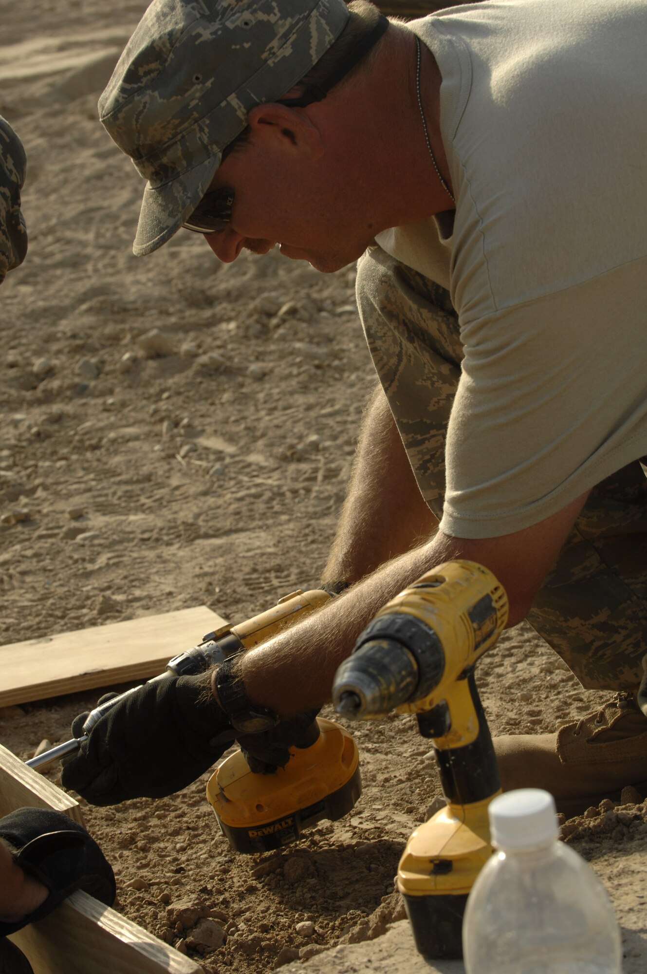 Staff Sgt. Amos Greer fastens wooden forms together Oct. 3 that will be used for the concrete footers for sun shades being installed on the Ali Base, Iraq, flightline.  Sergeant Greer and other Airmen in the 407th Civil Engineer Squadron are working around the clock to build the sun shades by November.  (U.S. Air Force photo/Airman 1st Class Jonathan Snyder) 