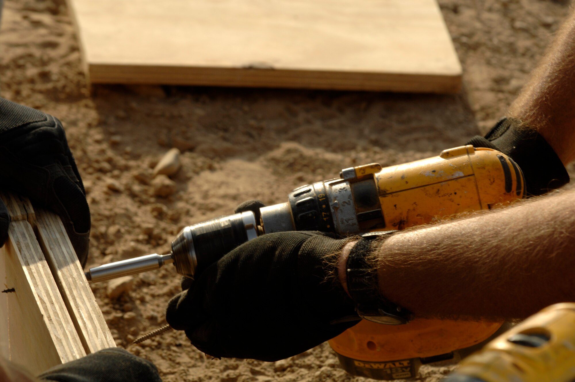 Staff Sgt. Amos Greer fastens wooden forms together Oct. 3 that will be used for the concrete footers for sun shades being installed on the Ali Base, Iraq, flightline.  Sergeant Greer and other Airmen in the 407th Civil Engineer Squadron are working around the clock to build the sun shades by November.  (U.S. Air Force photo/Airman 1st Class Jonathan Snyder) 