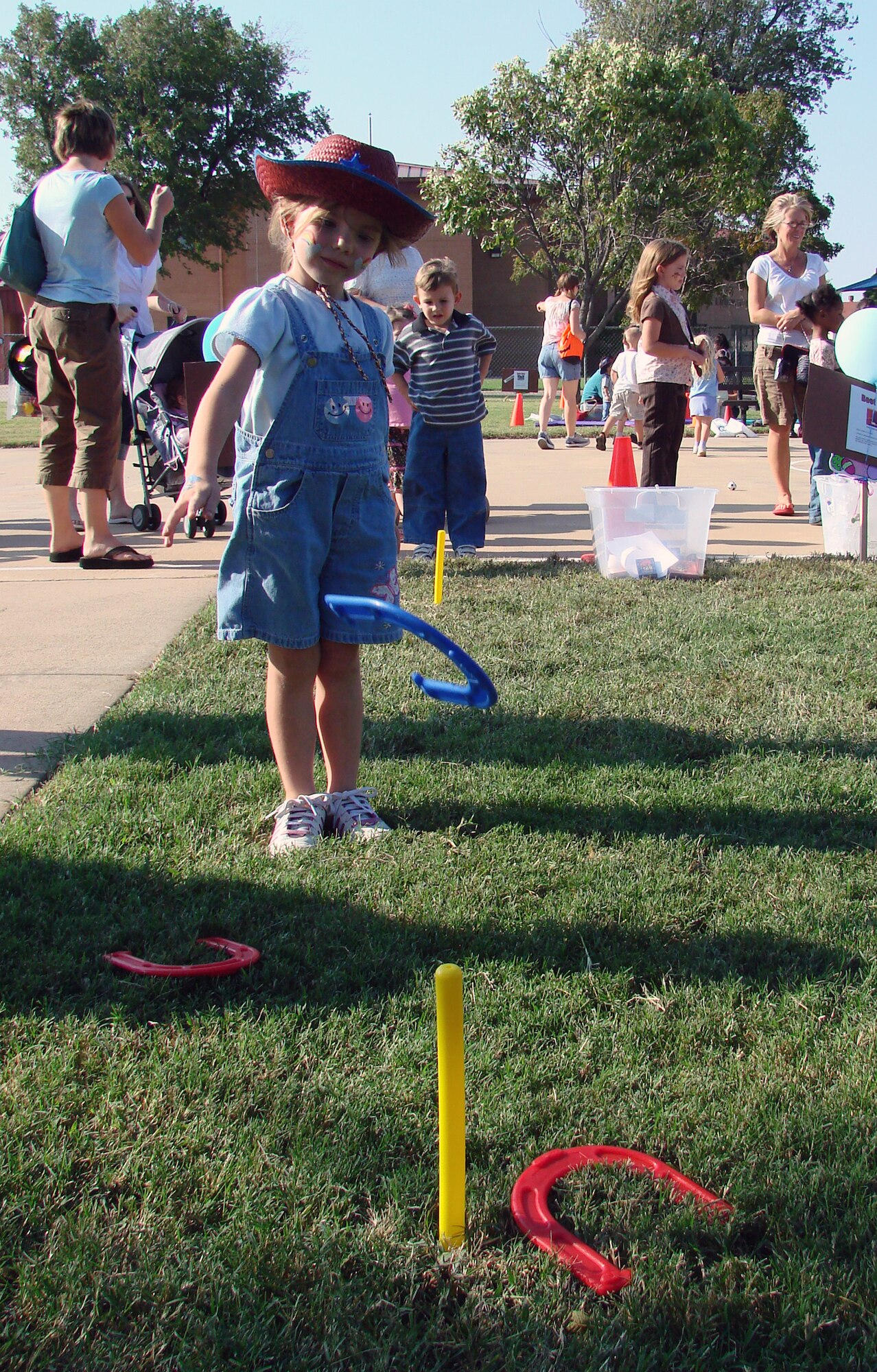 Four-year-old Makaley Waide throws a horseshoe at the children's festivities area during Fall Fest 2007 Oct. 4.  Makaley is the daughter of Jennifer and Greg Waide of the Airman & Family Readiness Center. (U.S. Air Force photo by Tech. Sgt. Mary Davis)         