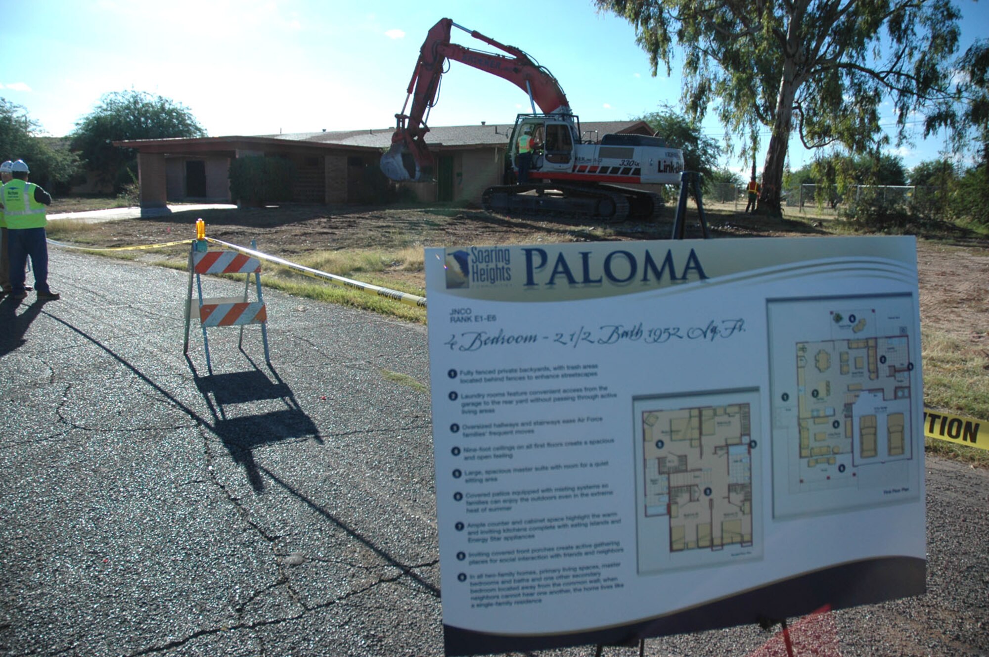Colonel Kent Laughbaum, 355th Fighter Wing commander, uses an excavator to demolish the first home being replaced as part of the $300 million privatized housing improvements here Oct. 5. This demolition marked the first of 868 old housing units scheduled to be demolished to make way for more than 500 new homes being constructed as part of the multi-million dollar privatization project. The new homes will feature state-of-the-art ENERGY STAR appliances, home office space with technology niches, covered porches for integrated indoor/outdoor living and spacious master bedroom suites. (U.S. Air Force photos by Staff Sgt. Tim Beckham)