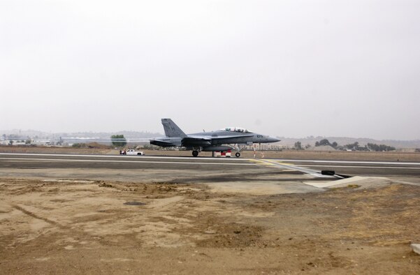 An F/A-18D Hornet from the Marine Fighter Attack Training Squadron at Miramar Marine Corps Air Station, Calif., conducted the initial certification of the south end retractable barrier at March Air Reserve Base, Calif. Sept. 28. The runway has a Type H90 retractable cable in place on both the north and south ends, thereby increasing safety measures for fighter pilots. The north end was completed and certified on July 7. (U.S. Air Force photo by Amy Abbott)