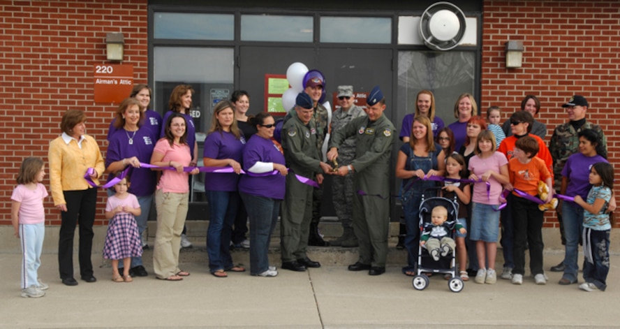 MINOT AIR FORCE BASE, N.D. -- Col. Bruce Emig, 5th Bomb Wing commander, and Col. Marty Whelan, 91st Space Wing commander cut a ribbon at the Airman's Attic here Oct. 4. The Airman's Attic had a grand re-opening after transferring sponsorship to the Enlisted Spouses Club. For more information on changes to the Airman's Attic, visit the newsbriefs page. (U.S. Air Force photo Airman 1st Class Joe Rivera)
