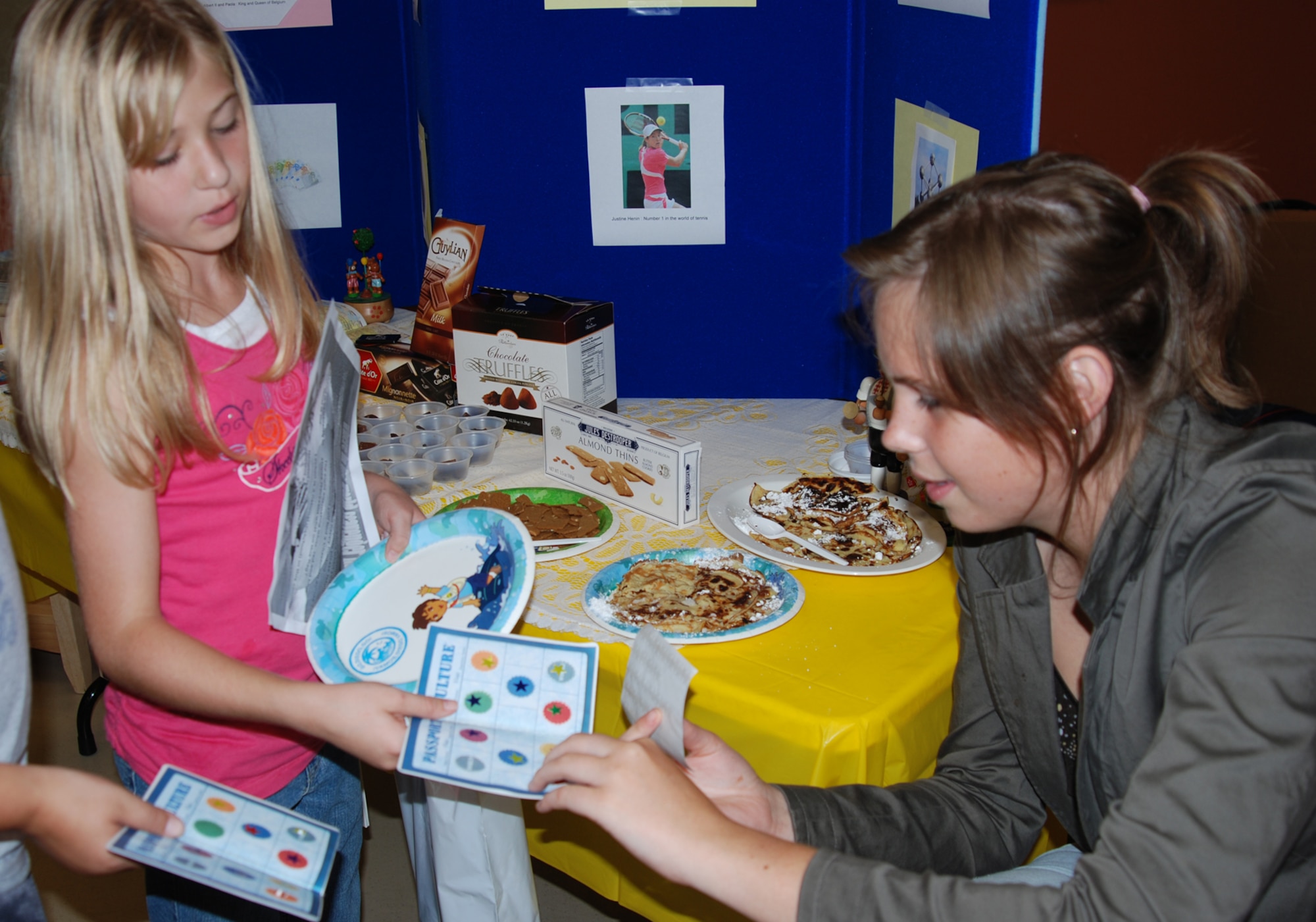 Audrey Quoitin, Team McConnell member and foreign exchange student, places a sticker on a McConnell youth’s passport Sept. 29 at the International Fair held at the Youth Center. Audrey not only represented Belgium as a native, she was able to share her countries cultures and tradition with fair participants. (photo by Airman 1st Class Jessica Lockoski)
