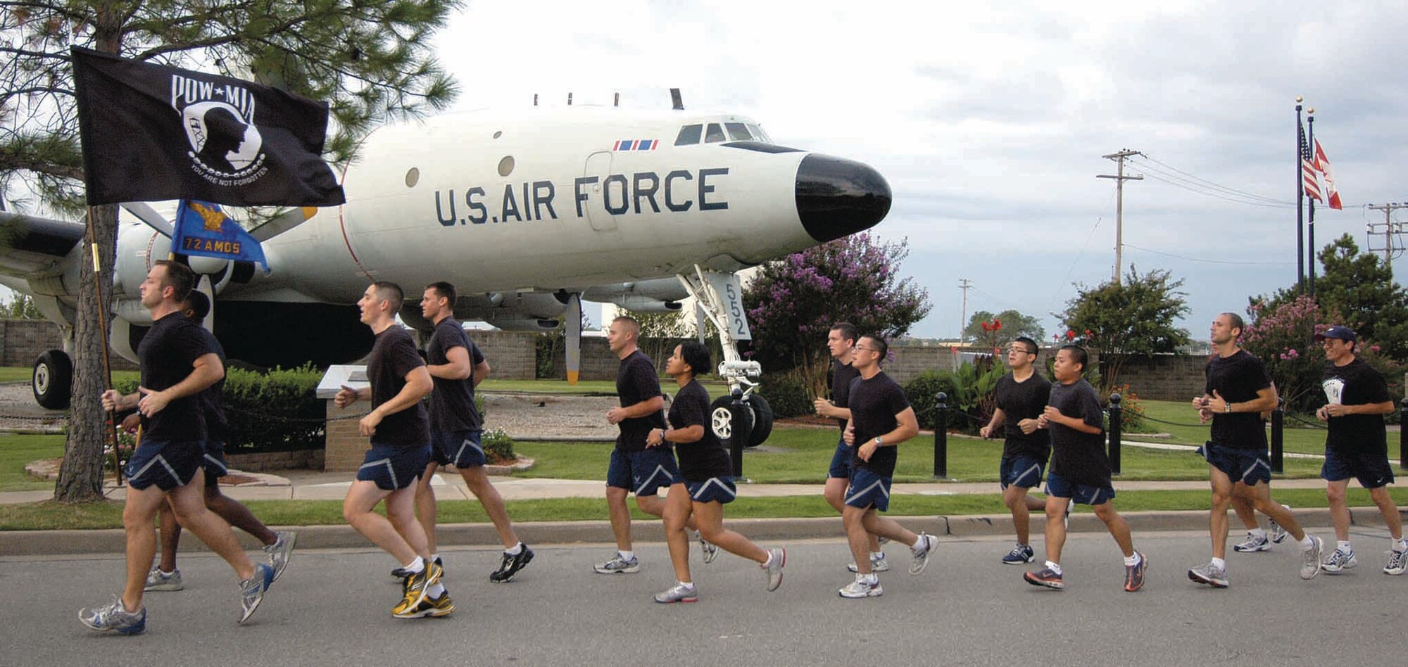 POW/MIA Memorial Run participants cruise past the 552nd Air Control Wing's E-C 121 aircraft affectionately termed Connie, used as a surveillance system in the Vietnam War era. Participants of the 5K run were asked to wear black to show solidarity and remembrance and run in pairs to show support for each other. (Air Force photo by Margo Wright)