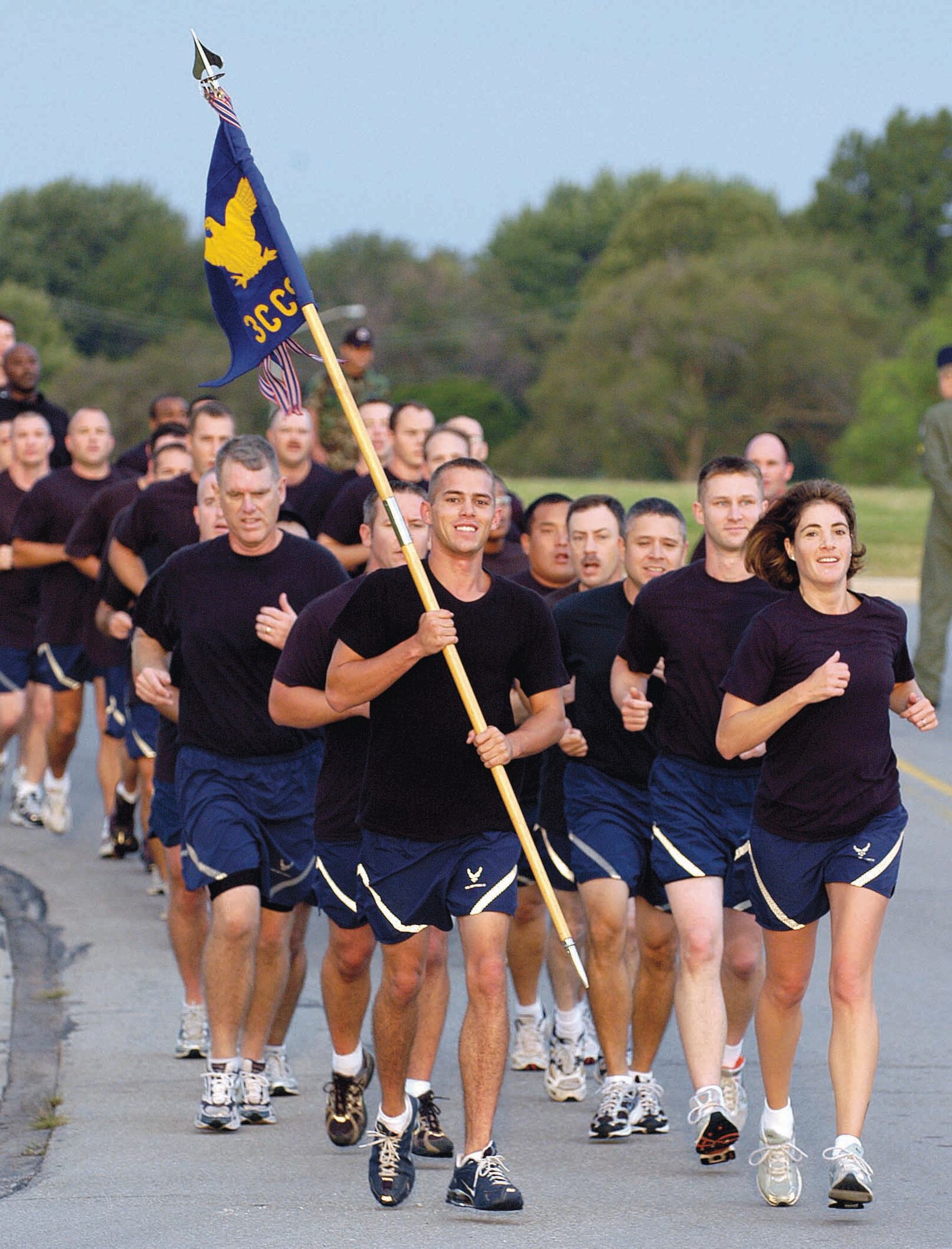 Maj. Vanessa Johnson, 3rd Combat Communications Support Squadron commander, front right, leads her troops in the second annual POW/MIA 5K memorial run on base. The 3rd Combat Communications Group had more than 500 runners participate. (Air Force photo by Margo Wright)