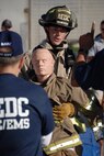 Firefighter Clint Montgomery drags a 175-pound rescue dummy a distance of 100 feet. (Photo by Rick Goodfriend)