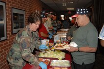 Tech. Sgt. Kimberly Pfender, AEDC legal office NCOIC, serves food. 