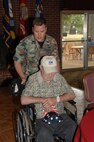1st Lieutenant Ricky Dickens, project manager for the 651st Test and Evaluation Support Squadron, helps a veteran get to the table for lunch. (Photos by David Housch)