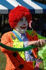 Dinky the clown makes balloon hats at the Air Force 60th anniversary event at Arnold Engineering Development Center’s Gossick Leadership Center Recreation Beach area. (Photo by David Housch)