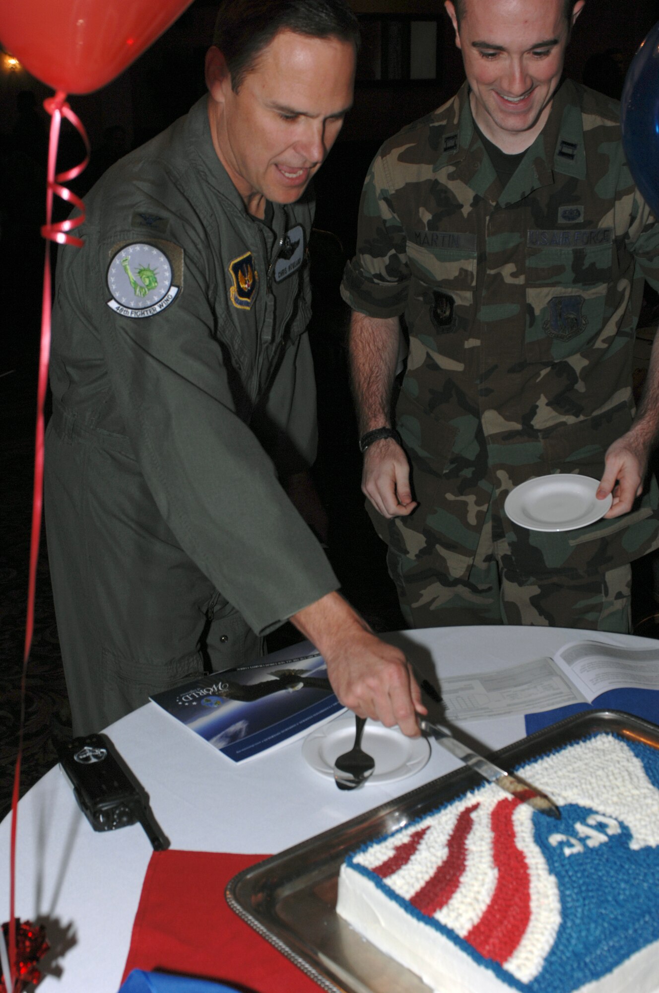 Col. Mark Nowland, 48th Fighter Wing vice commander, and Capt. Benjamin Martin, wing Combined Federal Campaign representative, cut into a cake during a ceremony at Eagles’ Landing Oct. 4. The ceremony celebrated the beginning of the campaign. All Liberty members may contribute the Combined Federal Campaign Overseas from now until Nov. 30. The CFC is the only authorized solicitation of employees in the federal workplace on behalf of charitable organizations and contributes to more than 1,900 charities worldwide. (U.S. Air Force photo by Senior Airman Shawn Gingrich)
