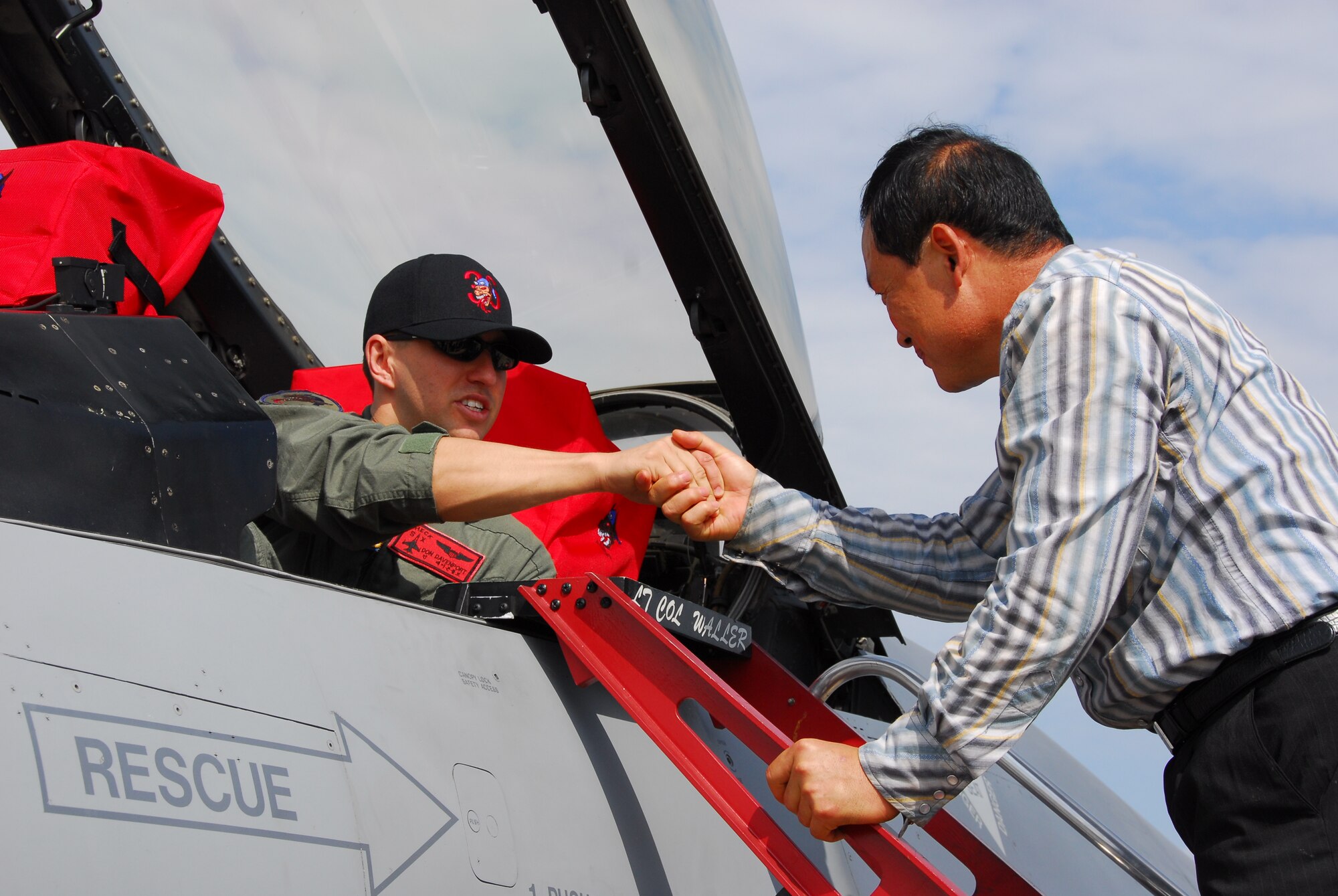 OSAN AIR BASE, Republic of Korea --  1st Lt. Don Davenport, 36th Fighter Squadron F-16 pilot, shakes hands with a Korean visitor at Air Power Day 2007 on Oct. 6 here. (U.S. Air Force photo by Staff Sgt. Ronnie Hill)