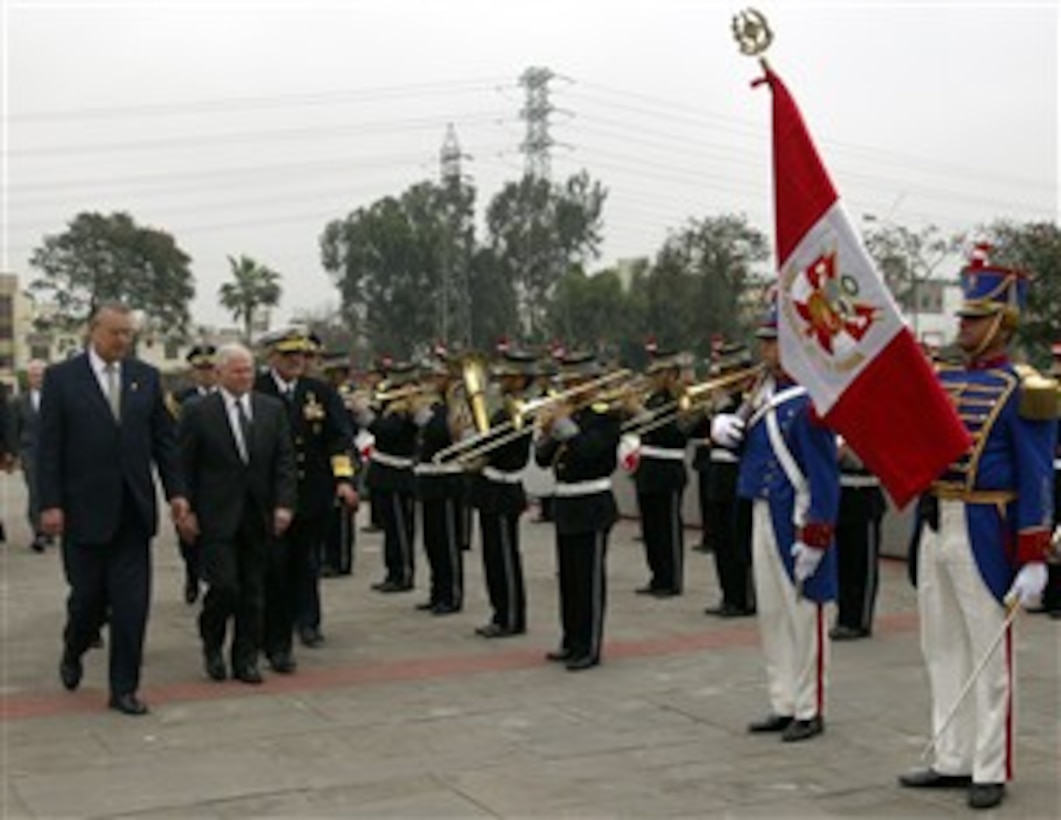 An honor guard salute greets Peru's Minister of Defense Allen Wagner, left, and U.S. Defense Robert M. Gates upon the secretary's arrival at Peruvian Army Headquarters in Lima, Peru, Oct. 5, 2007.  