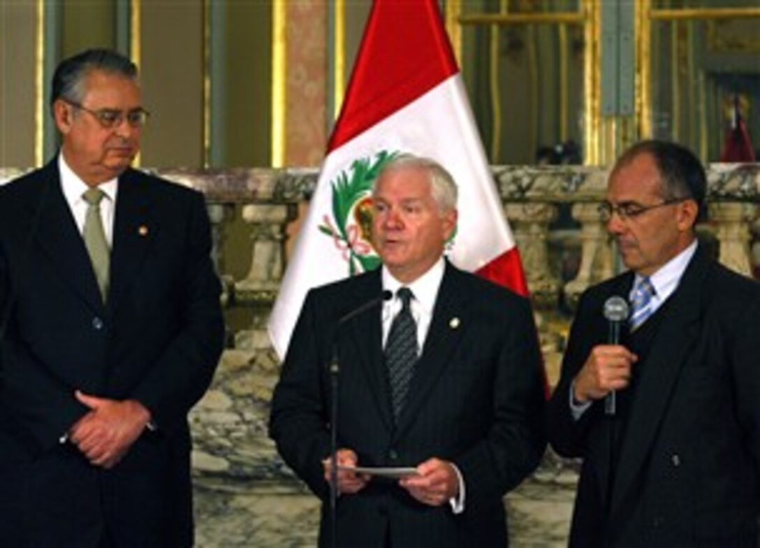 Peru's PRO National Director Carlos Pareja, left, and U.S. Secretary of Defense Robert M. Gates, assisted by a translater, right, hold a press conference at the presidential palace in Lima, Peru, Oct. 5, 2007.  The secretary is on a 5 day trip to Latin and South America to discuss defense issues with world leaders.   