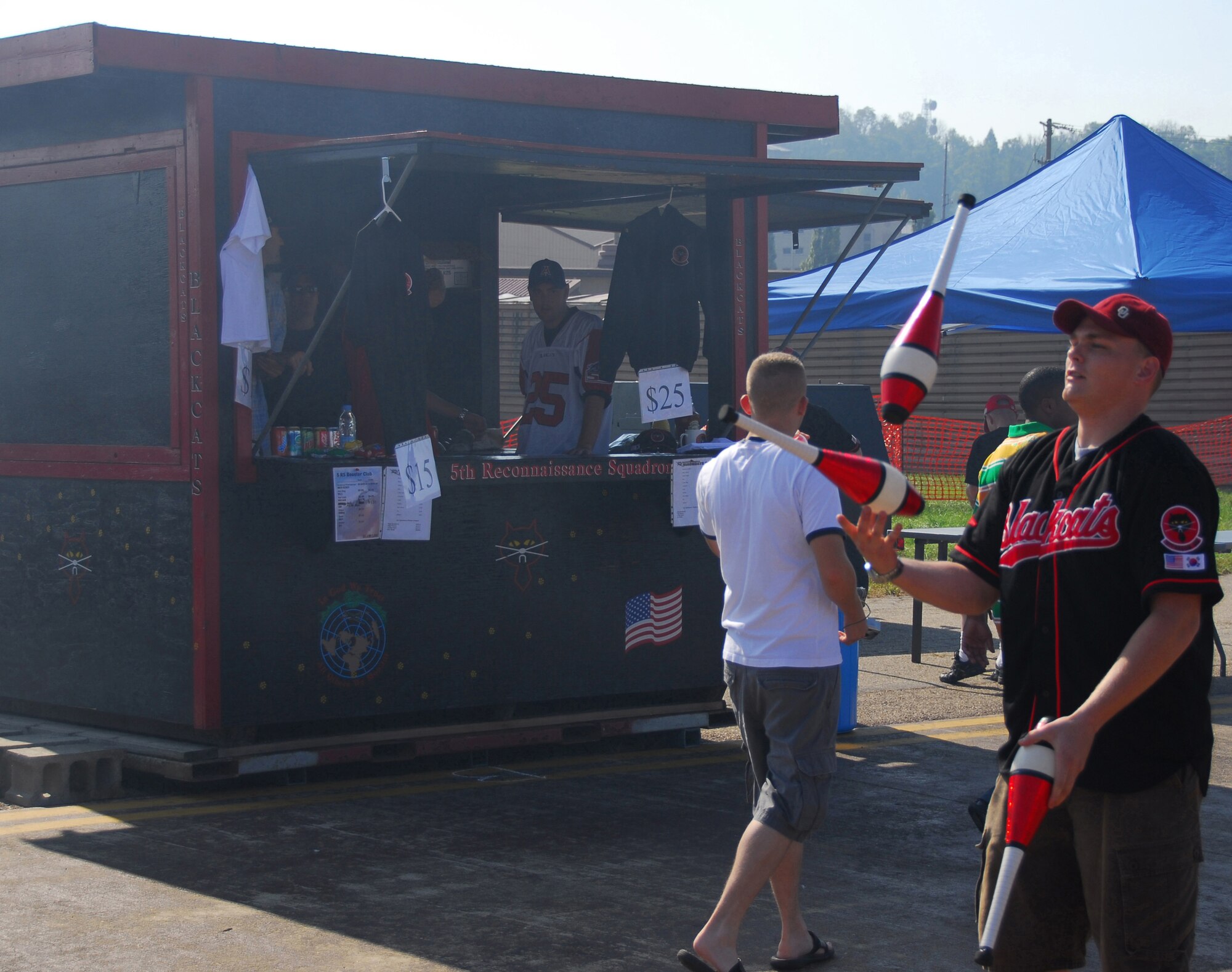 OSAN AIR BASE, Republic of Korea -- Senior Airmen Ryan Wade, 5th Reconnaissance Squadron, juggles to advertise the "BlackCats" food booth during Osan's Air Power Day October 7, 2007 (U.S. Air Force photo by Staff Sgt. Ronnie Hill)