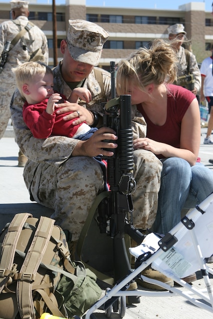Cpl. Matthew Beaudin, a fire direction control man with India Battery, 3/11, says goodbye to his wife, Kristie, and son, Matty, before departing the Combat Center Monday.