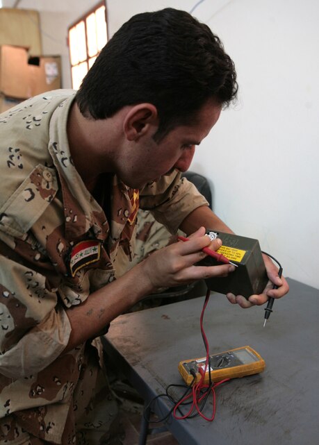 An Iraqi Soldier checks the charge of a radio battery at Camp Habbaniyah, Iraq on October 8, 2007. Communications Technicians with 1st Battalion, 1st Marines instruct Iraqi Soldiers on preventative maintenance and functions of radios to further broaden the capabilities of the Iraqi Army. Regimental Combat Team 6 is deployed with Multi National Forces-West in support of Operation Iraqi Freedom in the Al Anbar Province of Iraq to develop Iraqi Security Forces, facilitate the development of official rule of law through democratic reforms, and continue the development of a market based economy centered on Iraqi reconstruction.  (U.S. Marine Corps photo by Cpl. Neill A. Sevelius) (Released)