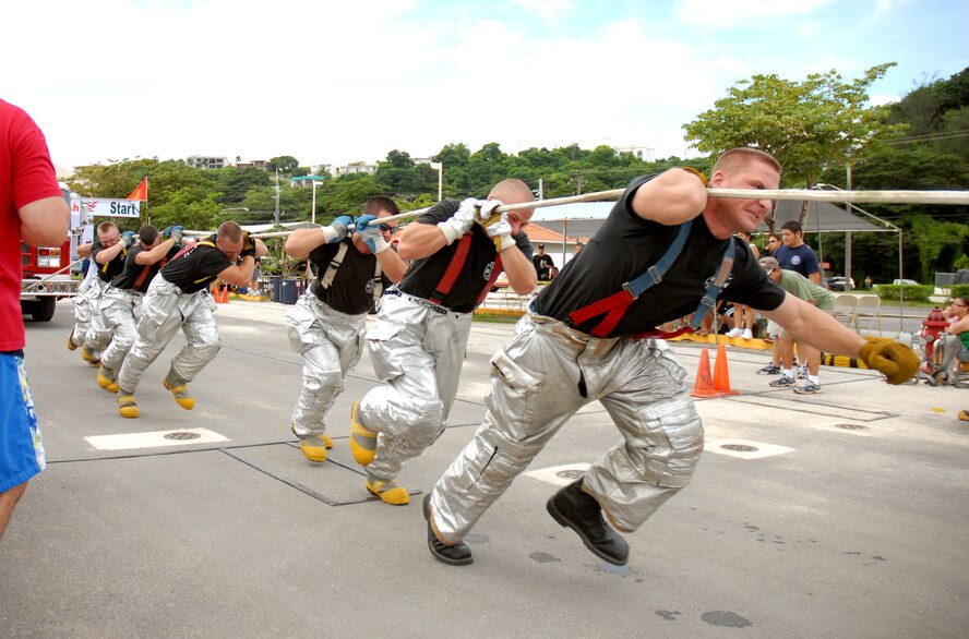 ANDERSEN AFB, GUAM---Andersen firefighters pull a fire engine, October 6, 2007, during the 2nd Annual Island-Wide Firefighter Muster that was held at the Agana Shopping Center in conjuction with Fire Prevention Week.  Andersen's Firefighters placed second overall for both days that the event was held.  Mr. Eric Masur, 36th Civil Engineering Squadron, placed first in the solo relay event.(U.S. Air Force photo by Senior Airman Miranda Moorer)(RELEASED)                                     