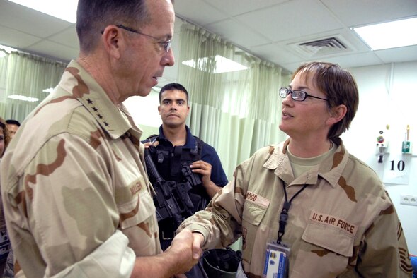 Senior Master Sgt. Angela Wood, superintendent for the 332nd Expeditionary Medical Support Squadron, meets and coins Adm. Mike Mullen, Chairman of the Joint Chiefs of Staff, with a Balad "Top 3 Council" coin, during his visit to Balad Air Base's Air Force Theater Hospital.  (U.S. Air Force photo/Staff Sgt. Joshua Garcia) 