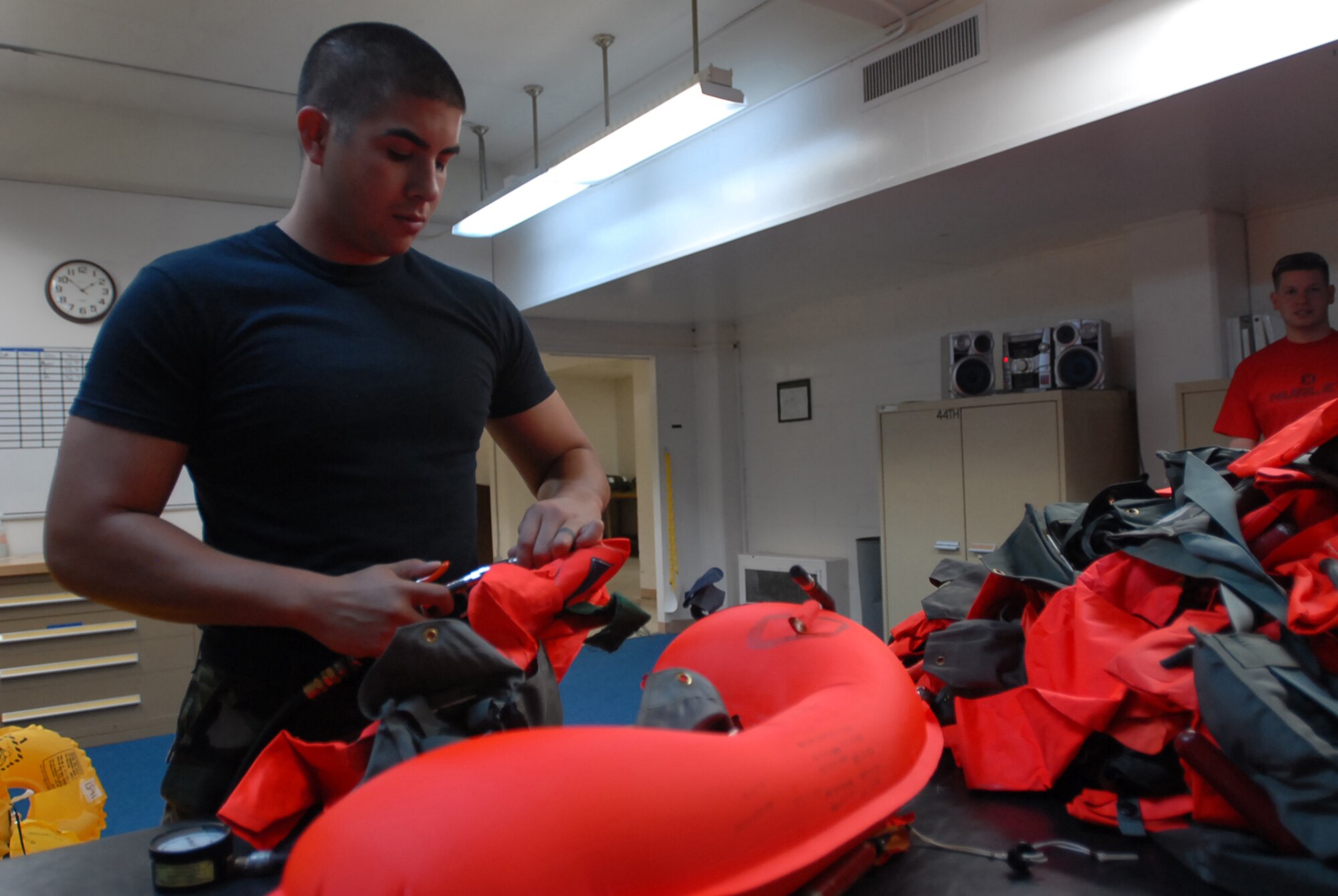 Senior Airman Adam Miranda inflates life preserving units at Kadena Air Base, Japan, Oct. 9, 2007 . The life preserving units are used in case someone has to make an emergency exit over water. Airman Miranda works with aircrew flight equipment in the 18th Operation Support Squadron.  (U.S. Air  Force photo/Senior Airman Darnell T. Cannady) 