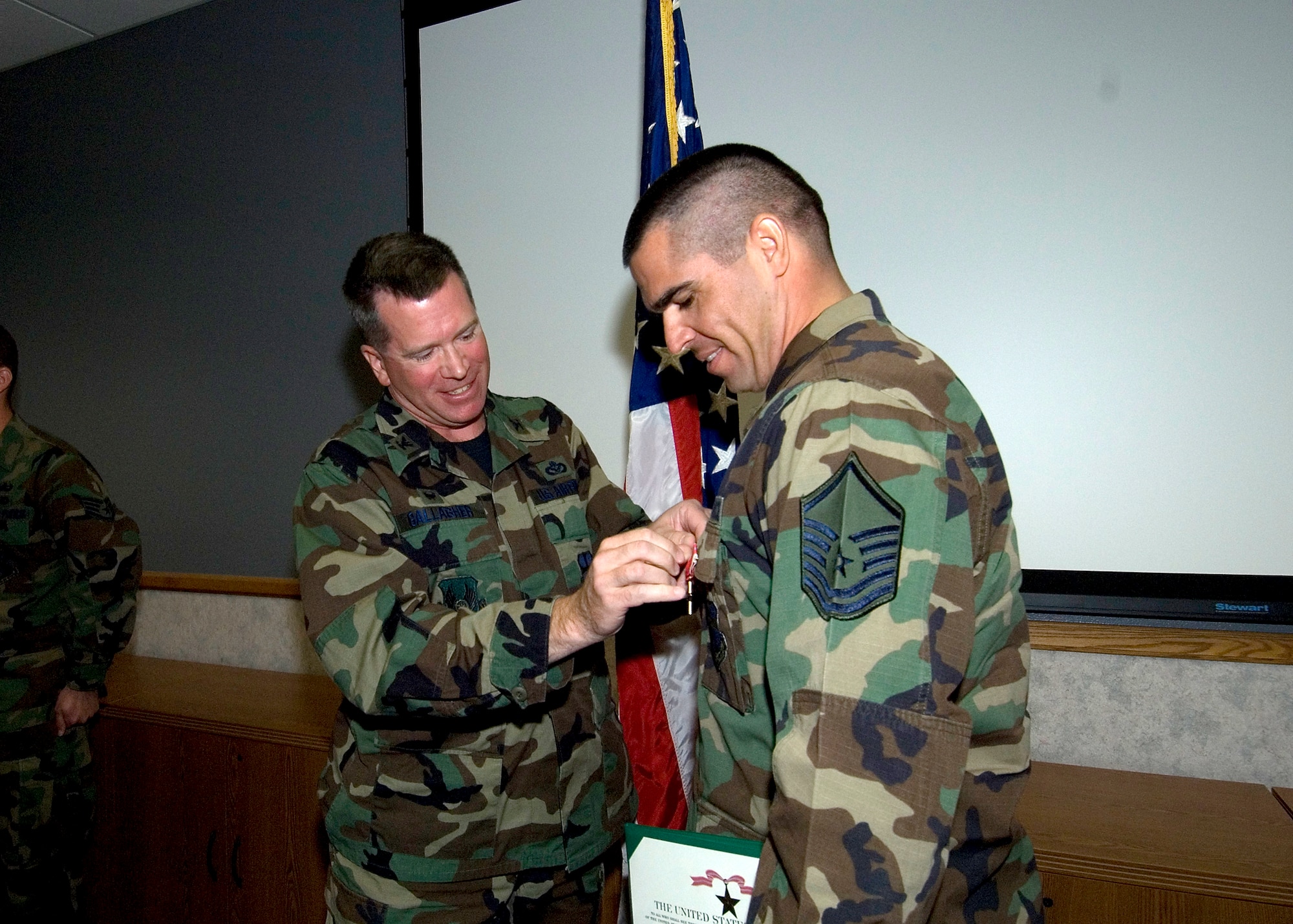 Col. Bryan Gallagher (left), 95th Air Base Wing commander, pins the Bronze Star Medal to Master Sgt. David Larriva, with the Explosive Ordnance Division, during a ceremony here Tuesday. Sergeant Larriva received the award for his gallantry during a deployment in support of Operation Iraqi Freedom. (Photo by Edward Cannon)