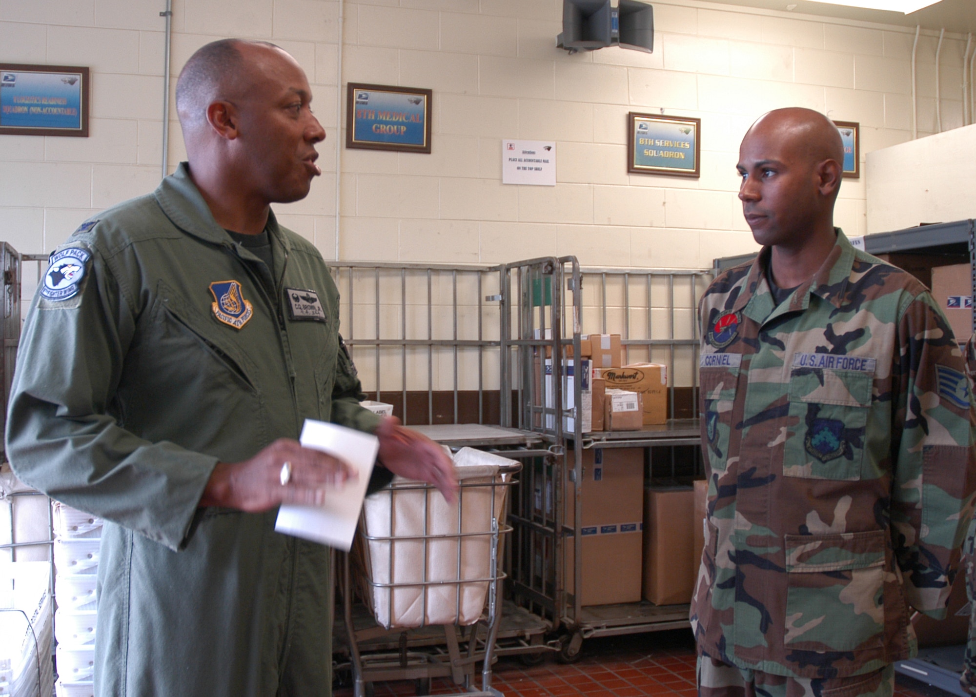 KUNSAN AIR BASE, South Korea -- Col. CQ "Wolf" Brown, 8th Fighter Wing commander, congratulates Staff Sgt. Saulo Corniel, 8th Communications Squadron, at his work center here Oct. 3. Sergeant Corniel was selected as the 8th Fighter Wing's Pride of the Pack for the week of Oct. 1. (U.S. Air Force photo/Staff Sgt. Araceli Alarcon) 