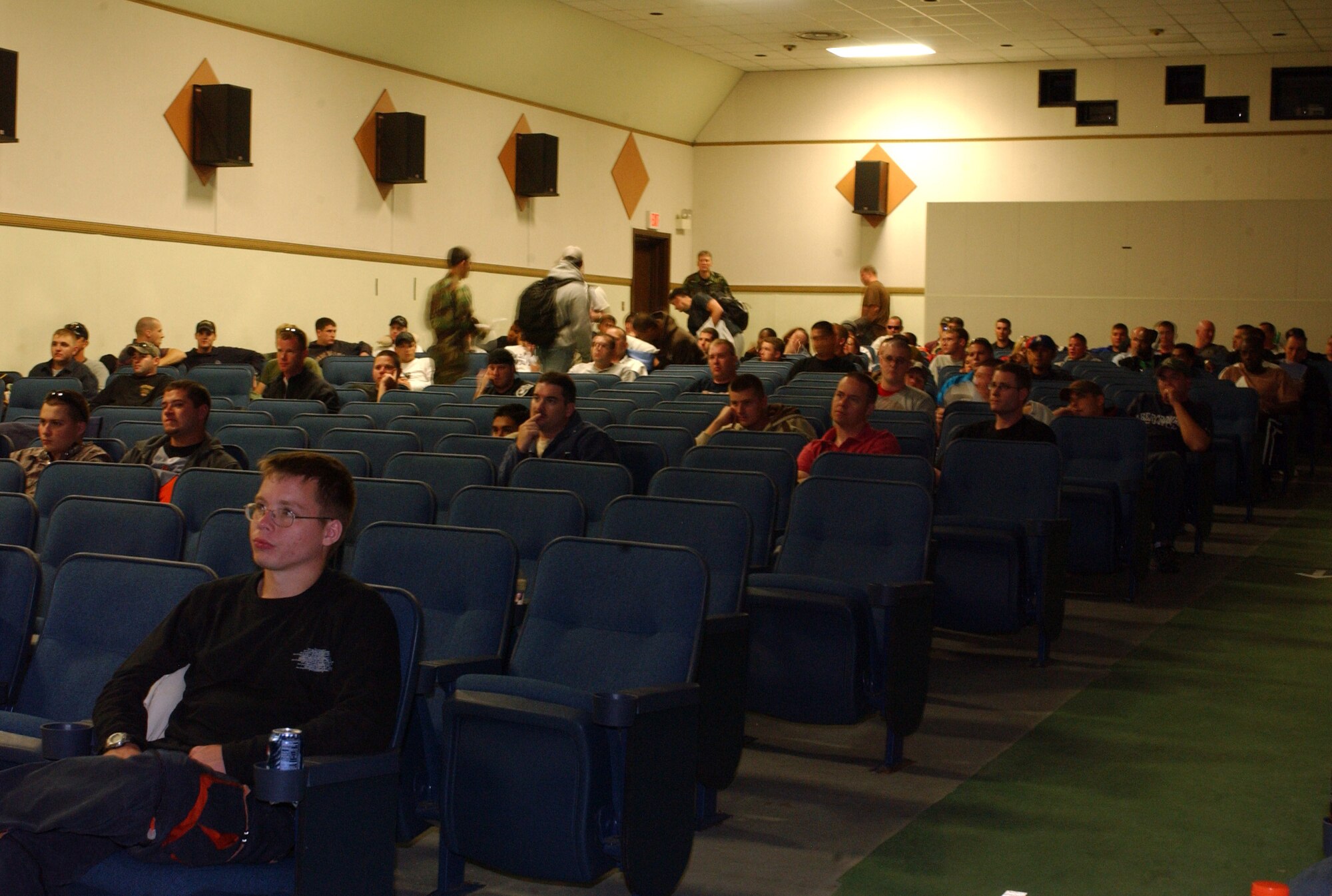 KUNSAN AIR BASE, South Korea -- Airmen from the 555th Expeditionary Fighter Squadron, wait inside the base theater here Oct. 8, in preparation for their redeployment back to Aviano Air Base, Italy after a four-month deployment here. The deployment is part of a continued commitment the U.S. has to South Korea to ensure stability and security in the region. The deployment was also the first for a United States Air Forces in Europe unit to deploy to a Pacific Air Forces base. (U.S. Air Force photo/Senior Airman Steven R. Doty)