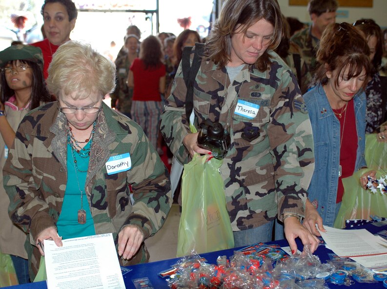 Teachers from the Travis Unified School District pick up additional information during the "welcome home" portion of the Teachers Understanding Deployment Operations event Oct. 3. The 60th Mission Support Squadron-sponsored event was designed to give teachers a better understanding of deployments and how it may affect their students by having them experience their own mock deployment. (U.S. Air Force photo/Staff Sgt. Candy Knight)