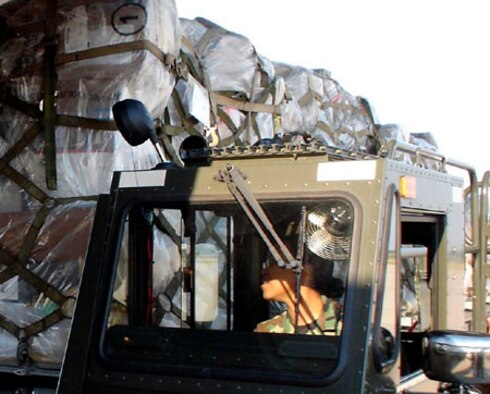 Senior Airman Jezzel Calderon, 45th Aerial Port Squadron, unloads cargo from the 60K transport vehicle during Patriot Partner exercise, Norfolk, Va., recently. (U.S. photo by Capt. Kelly Gabel, 349th Public Affairs)

